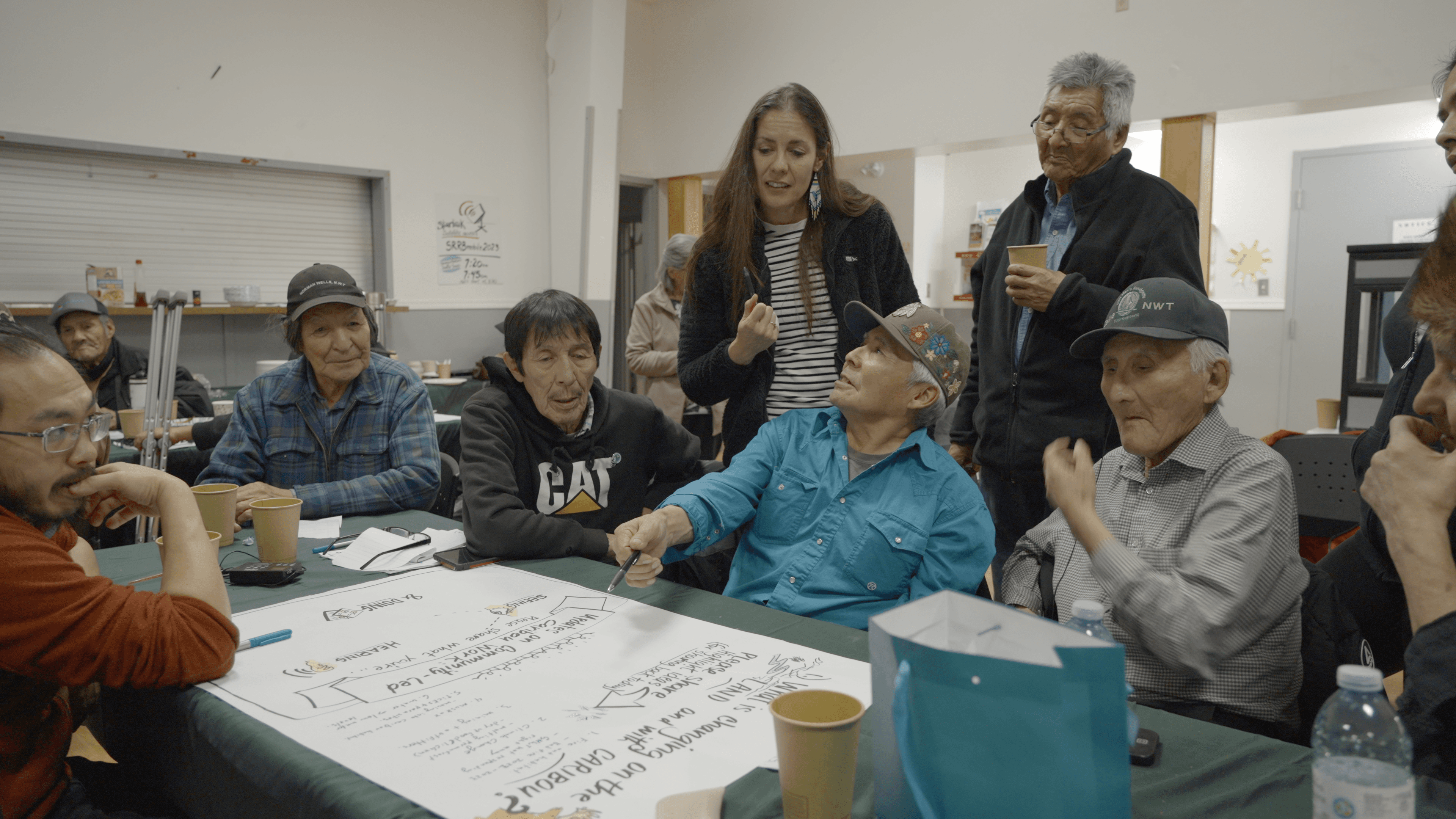 Indigenous community gathering around a table,