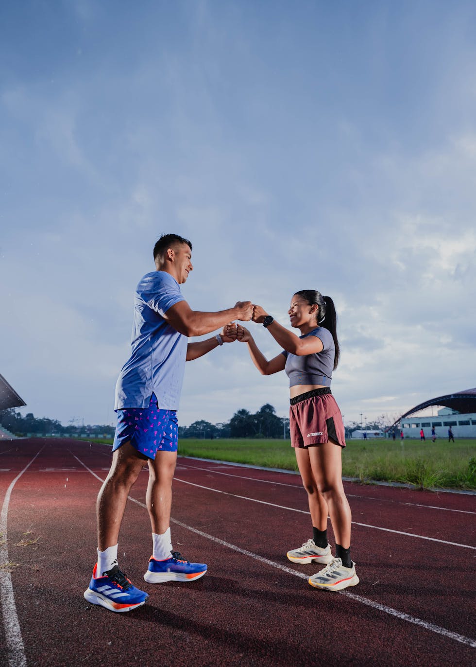 Couple holding hands on a track