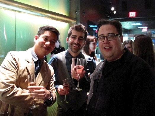 photo of three men having, each having a glass of champaign