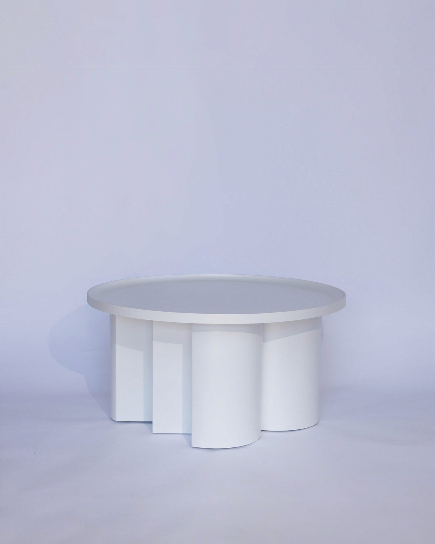 Stella table in solid material with central structural support and minimal design by Jiri Krejcirik
