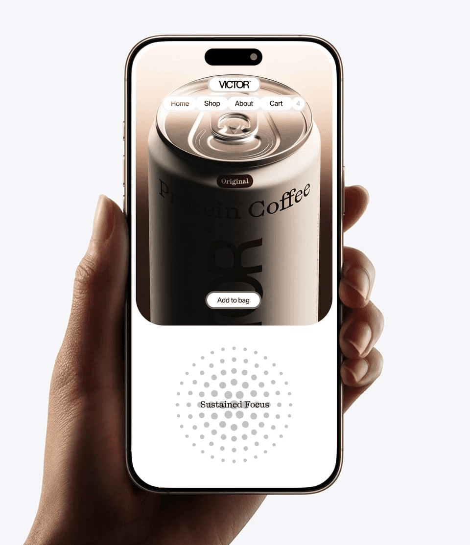 A hand holding a phone in which appears a can of coffe from VICTOR's project.