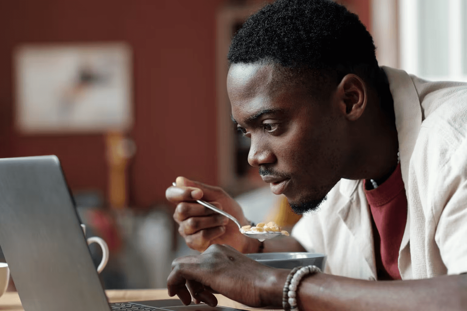 Man eats cereal while browsing laptop - Brainrot Examples