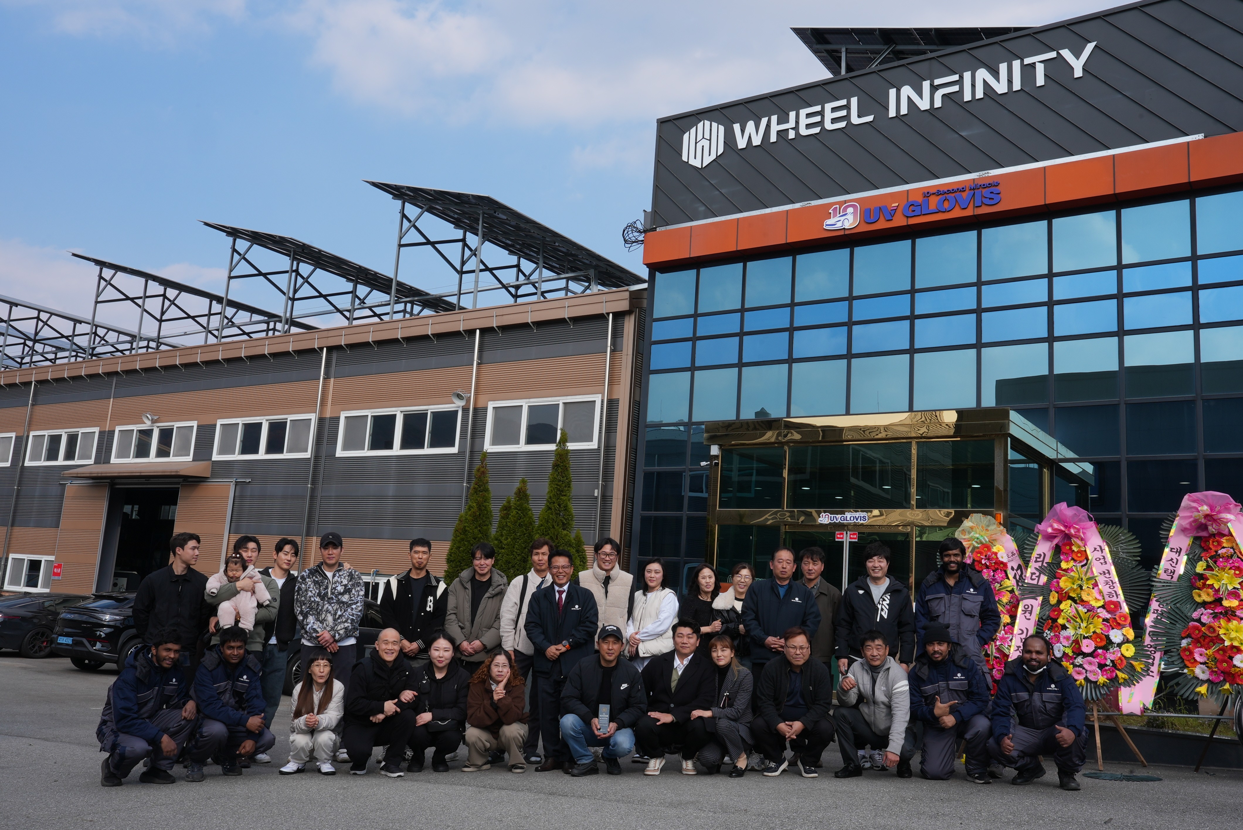 Modern indoor space with large glass doors, lush greenery, and a cozy seating area visible beyond.