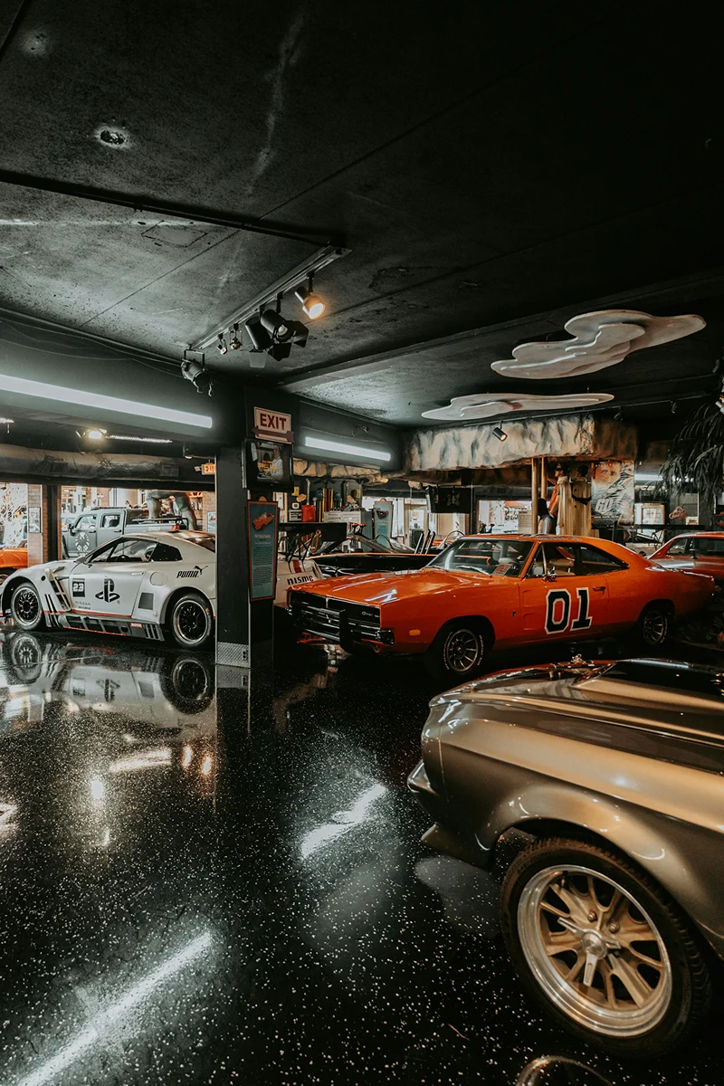 Classic cars displayed inside a dark automotive showroom
