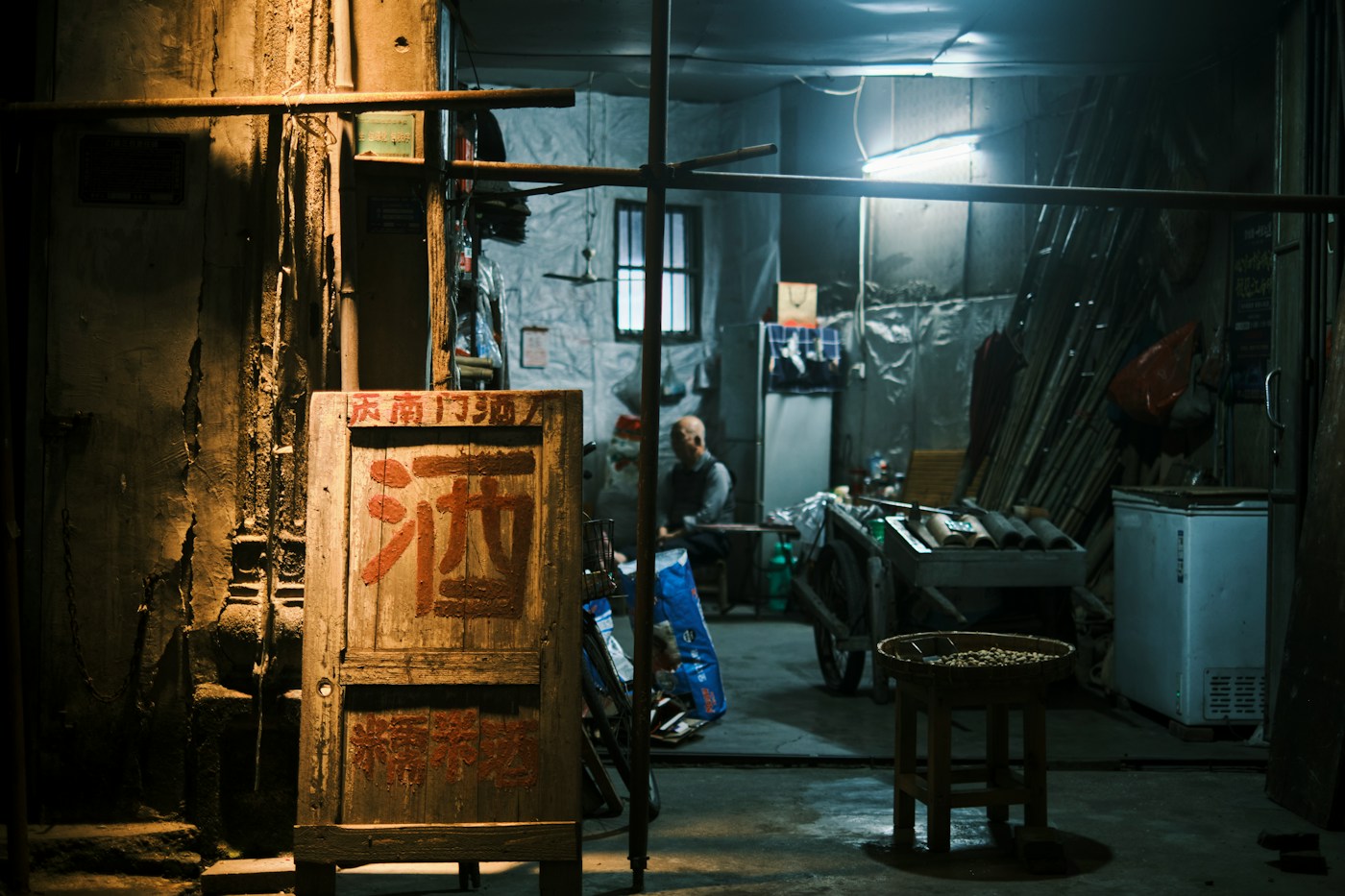 person sitting alone in front of an old television in a dim room