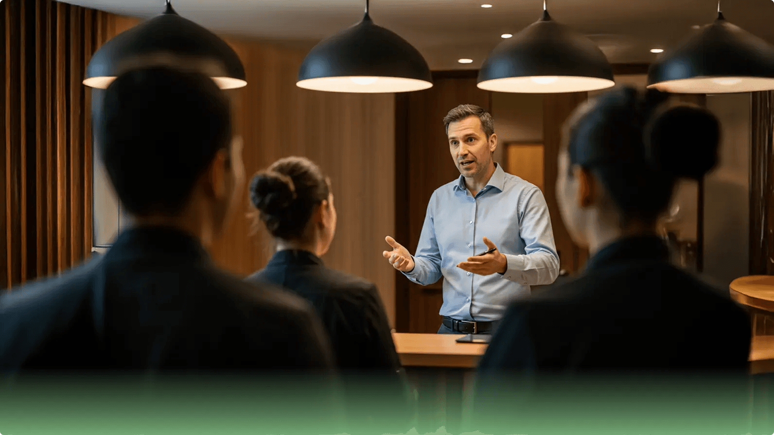 Host speaking to staff