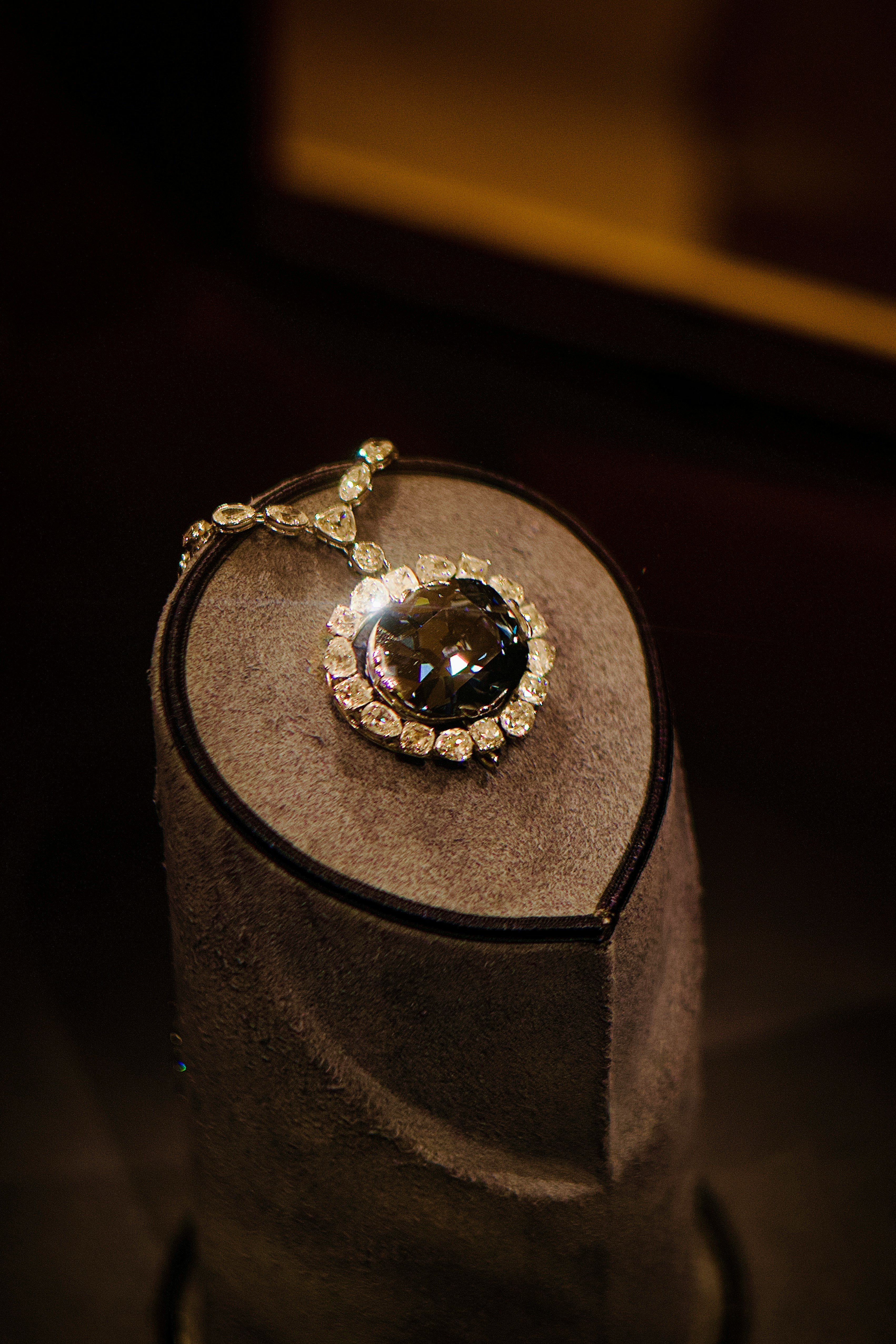 Large diamond pendant necklace on display stand