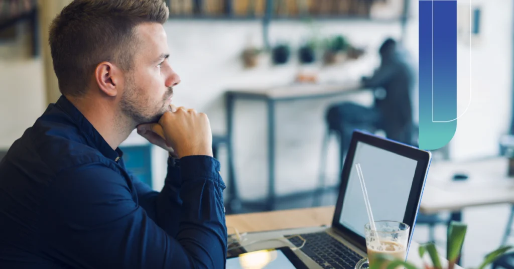 Marketing manager reviewing a video production company's portfolio on a laptop