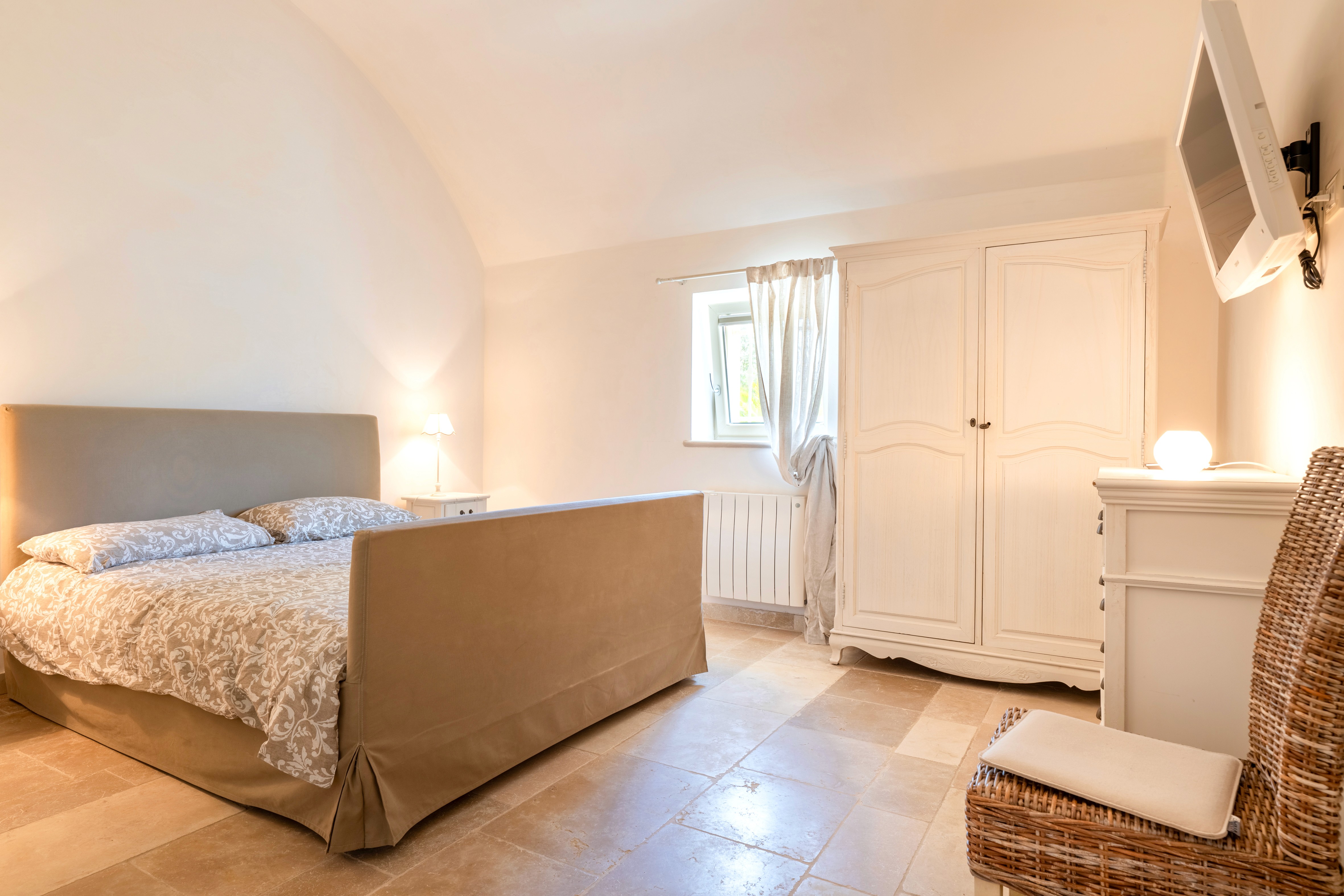 Modern living room with black leather sofas and tree-patterned rug