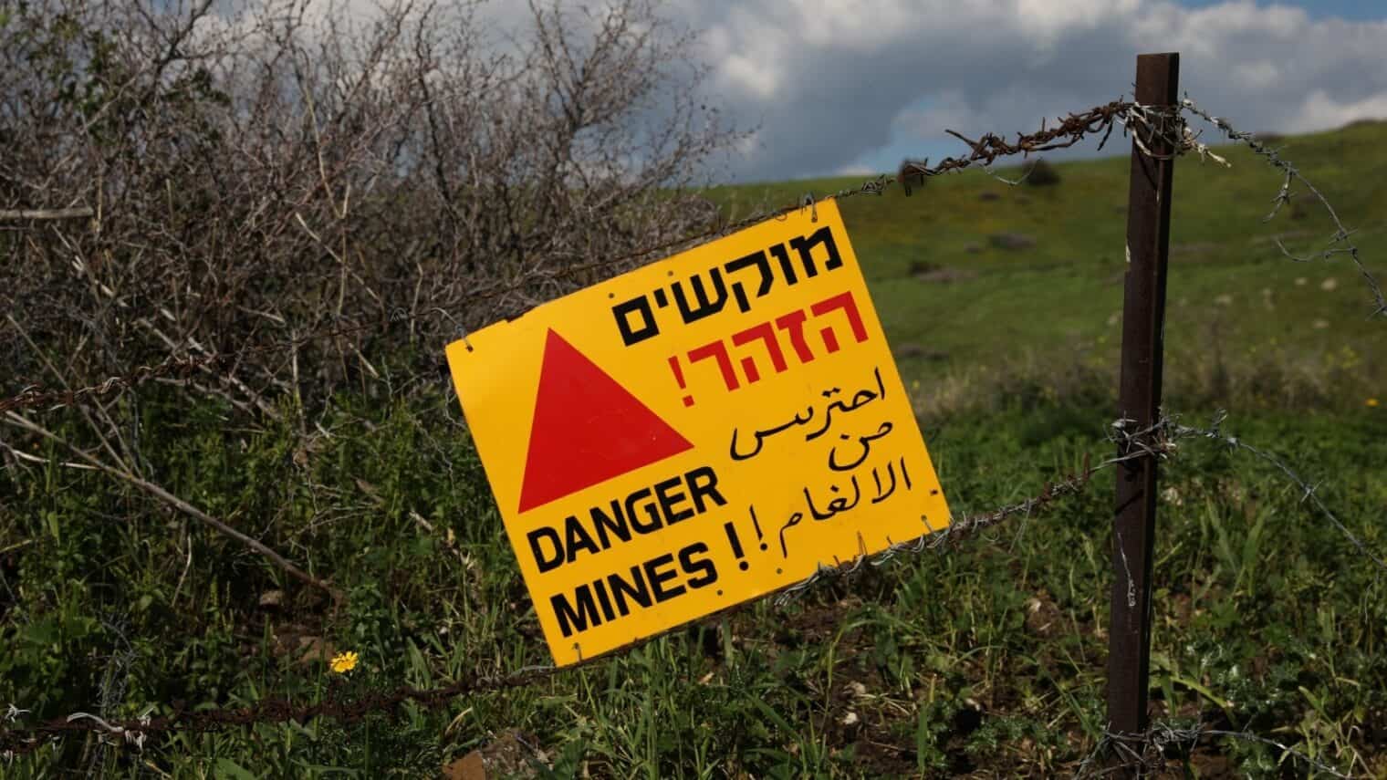 "Danger Mines" in multiple languages, set against a grassy landscape.
