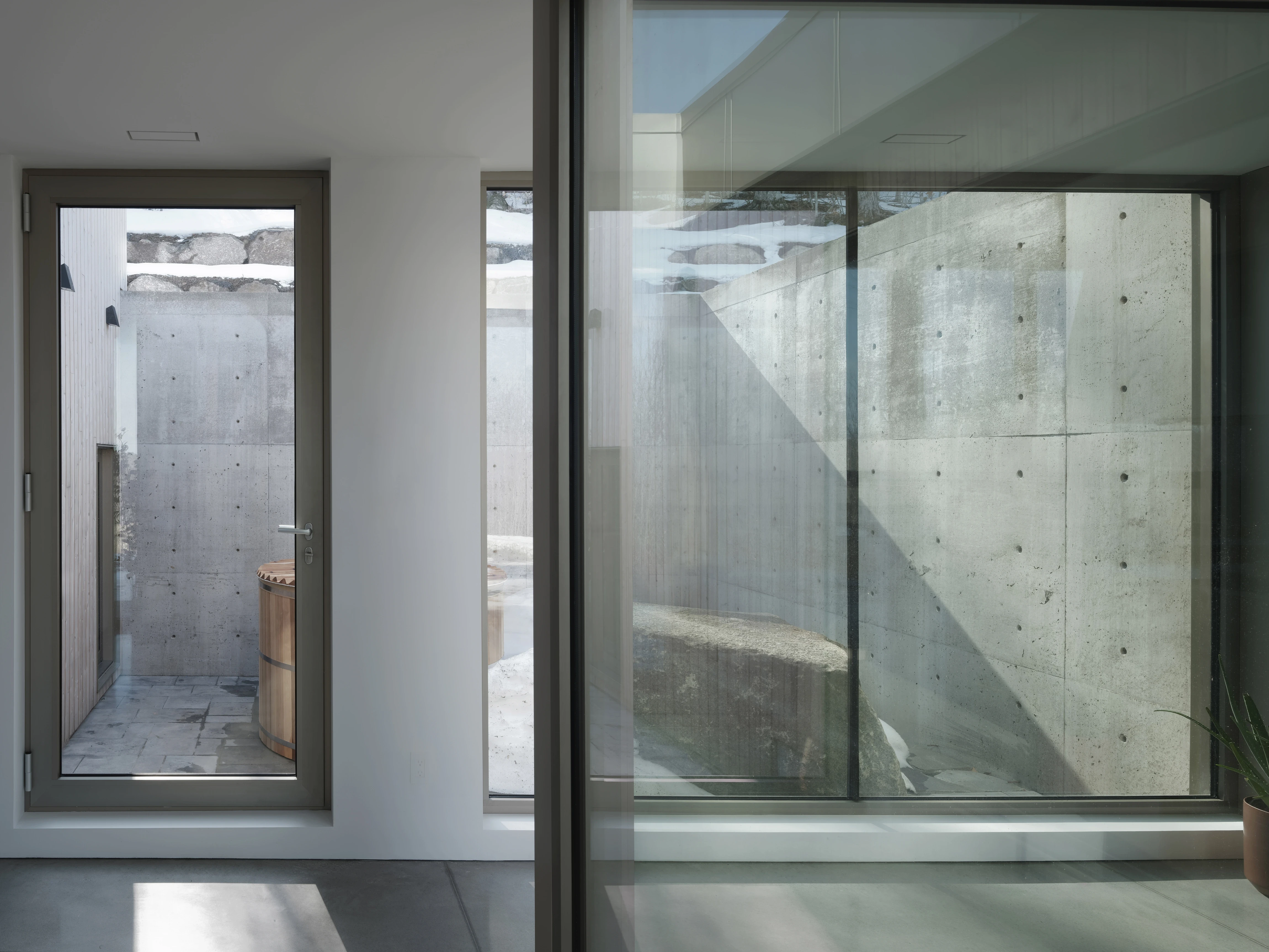 Transitional glass corridor – A sleek passageway with steel and glass elements, seamlessly connecting indoor and outdoor spaces.