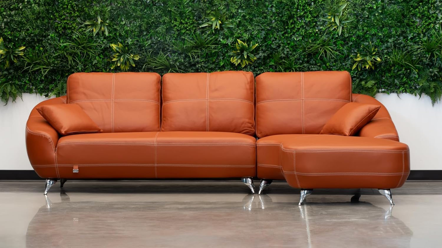 Stylish orange leather sofa with deep seating and a modern silhouette, ideal for creating a warm and inviting atmosphere.