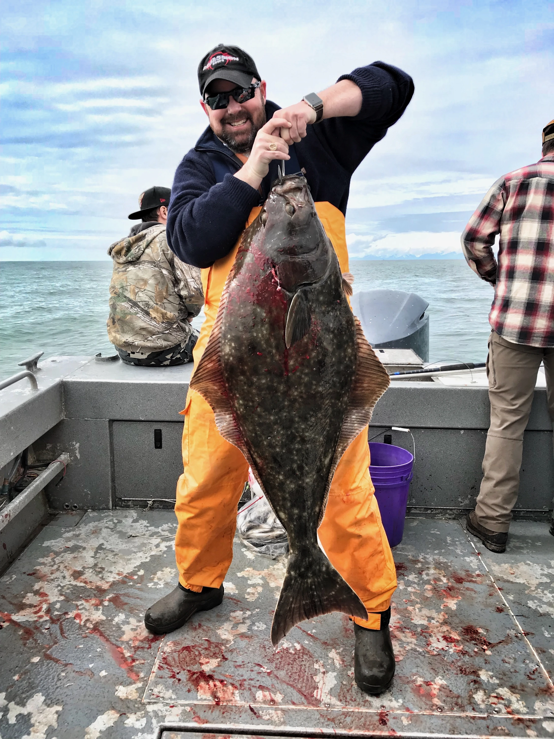 Person holding a fish on a boat