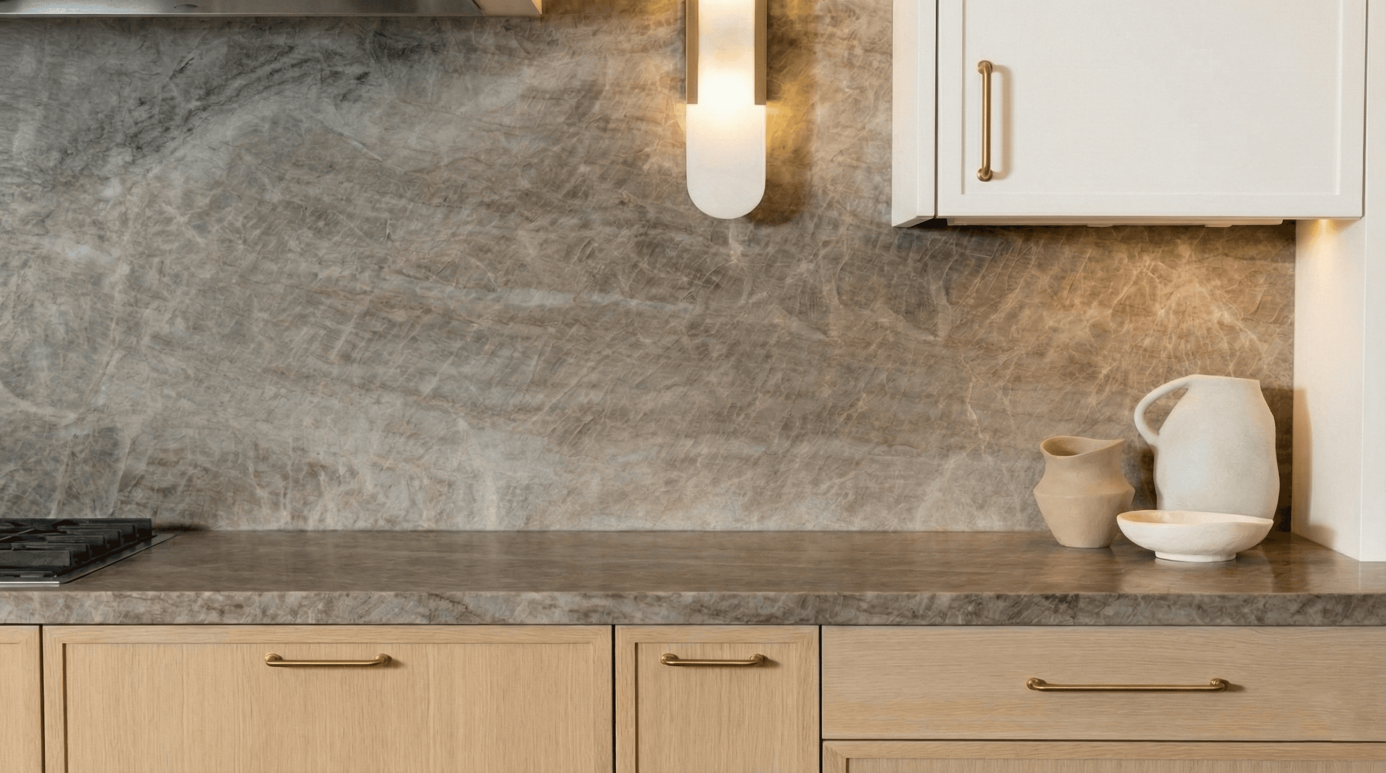 madre perla quartzite stone kitchen countertop installation by usa granite in dallas fort worth with oak cabinets and gold hardware modern neutral interior design