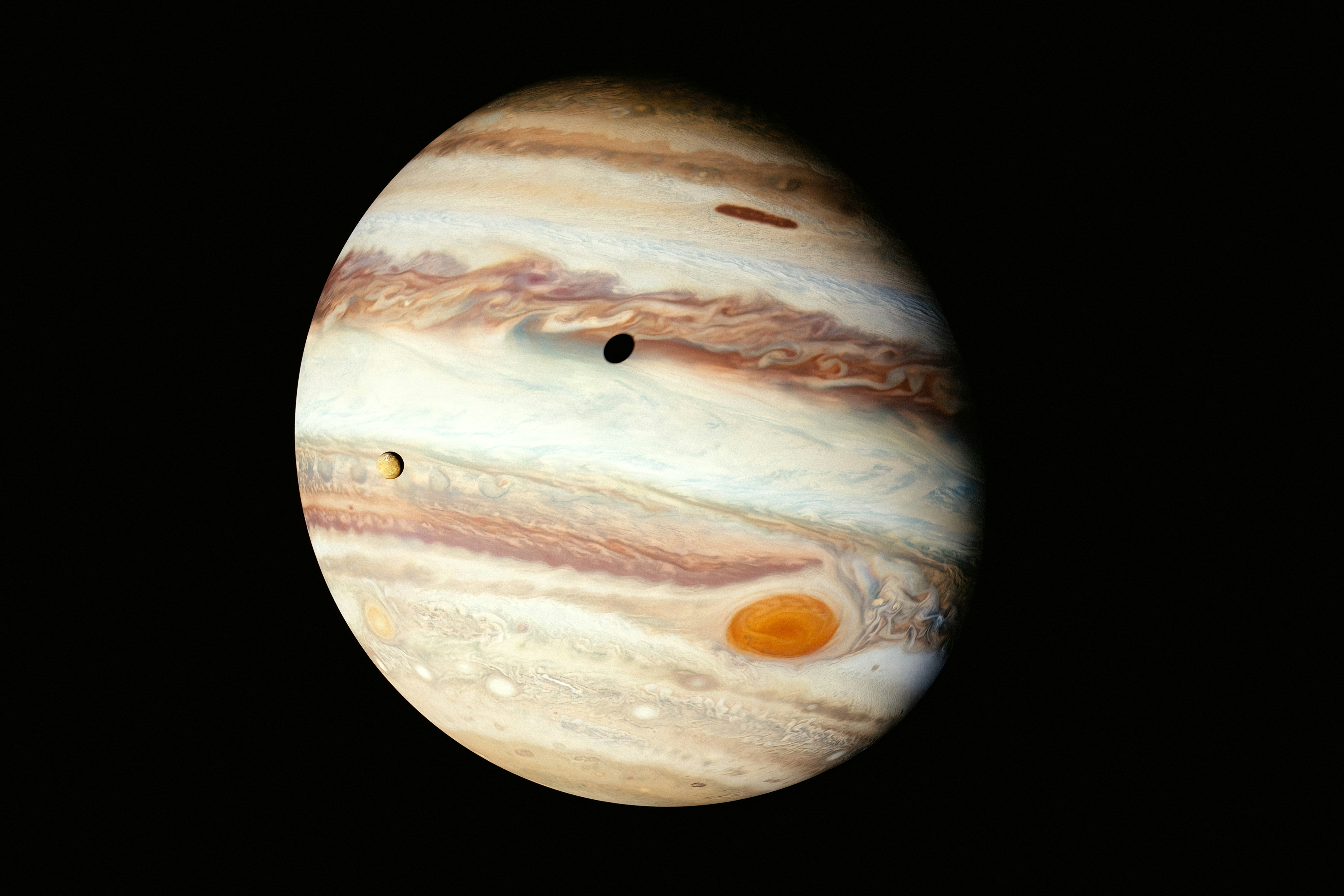 Jupiter with its great red spot and moons