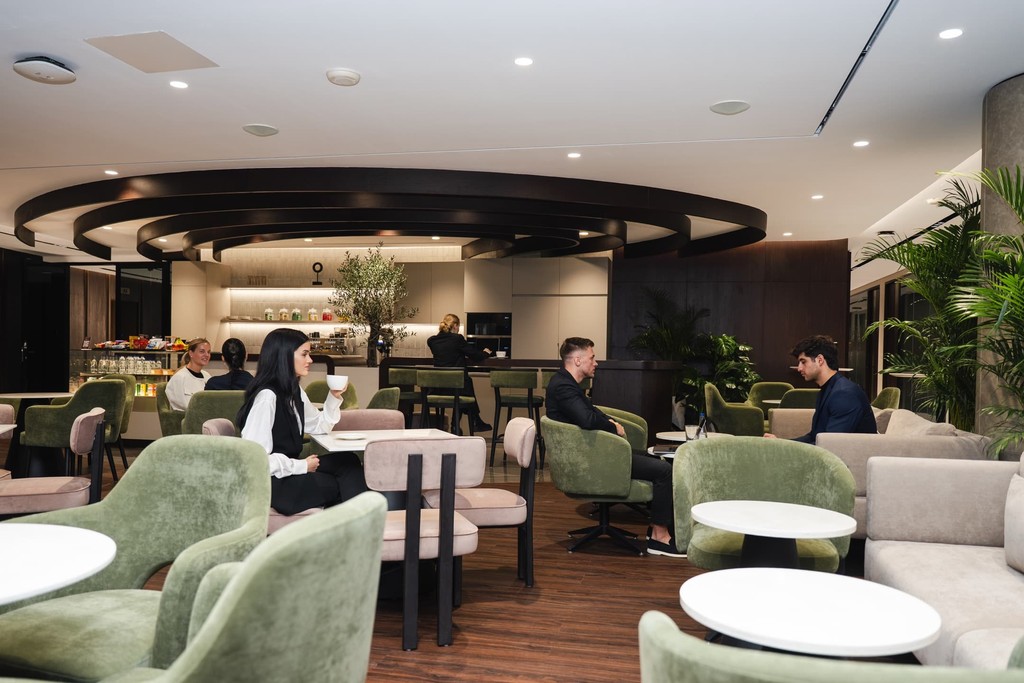 A coworking space cafe features a modern lounge area.