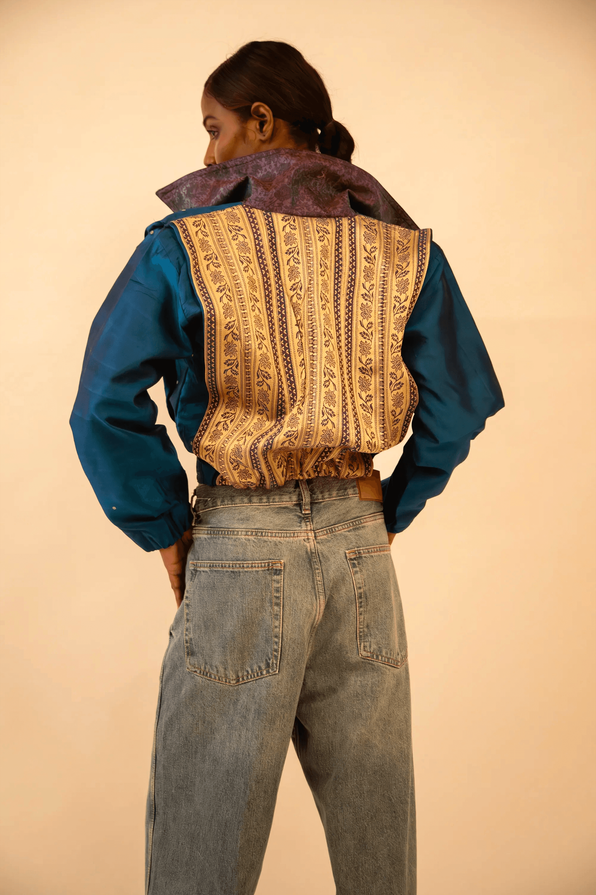 AMBR is our one-of-a-kind cropped two-toned silk brocade&nbsp; bomber jacket, handcrafted by skilled artisans in-house using a vintage silk saris