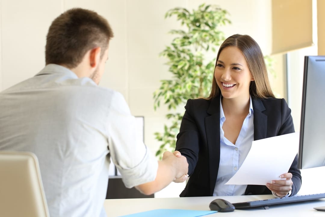 man and woman working shaking hands