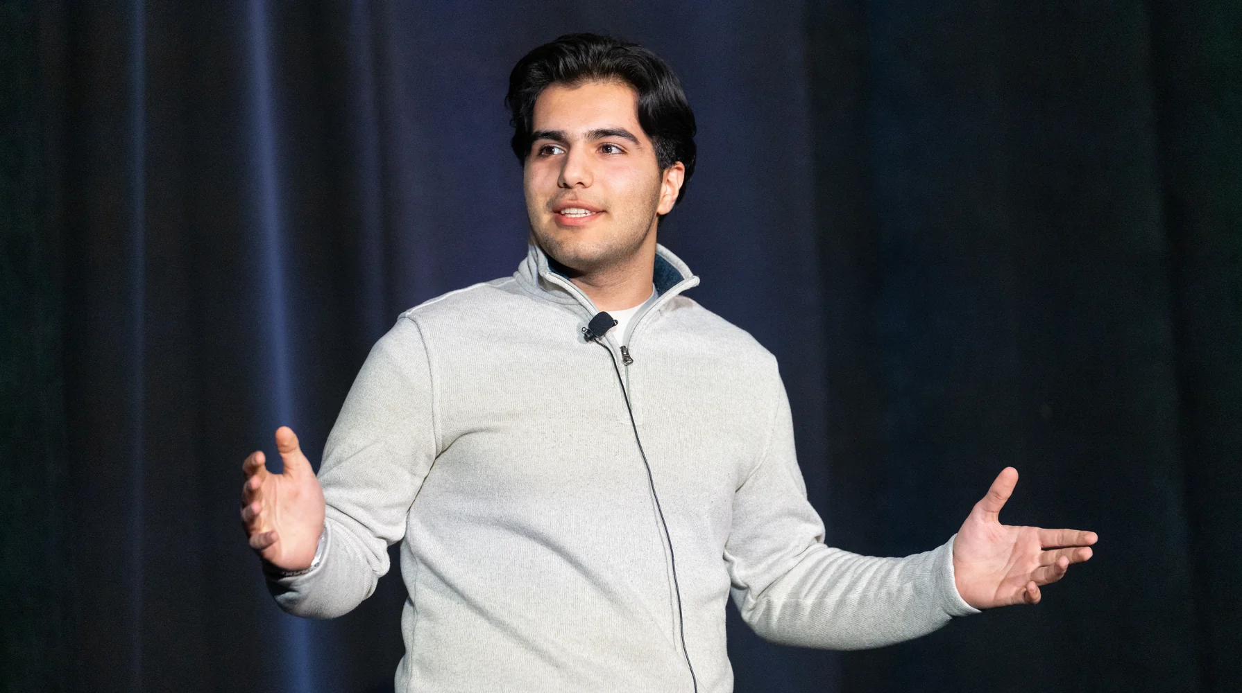 Amirali Rezaei pitching AISA on stage at Accelerate 2025 in Cleveland