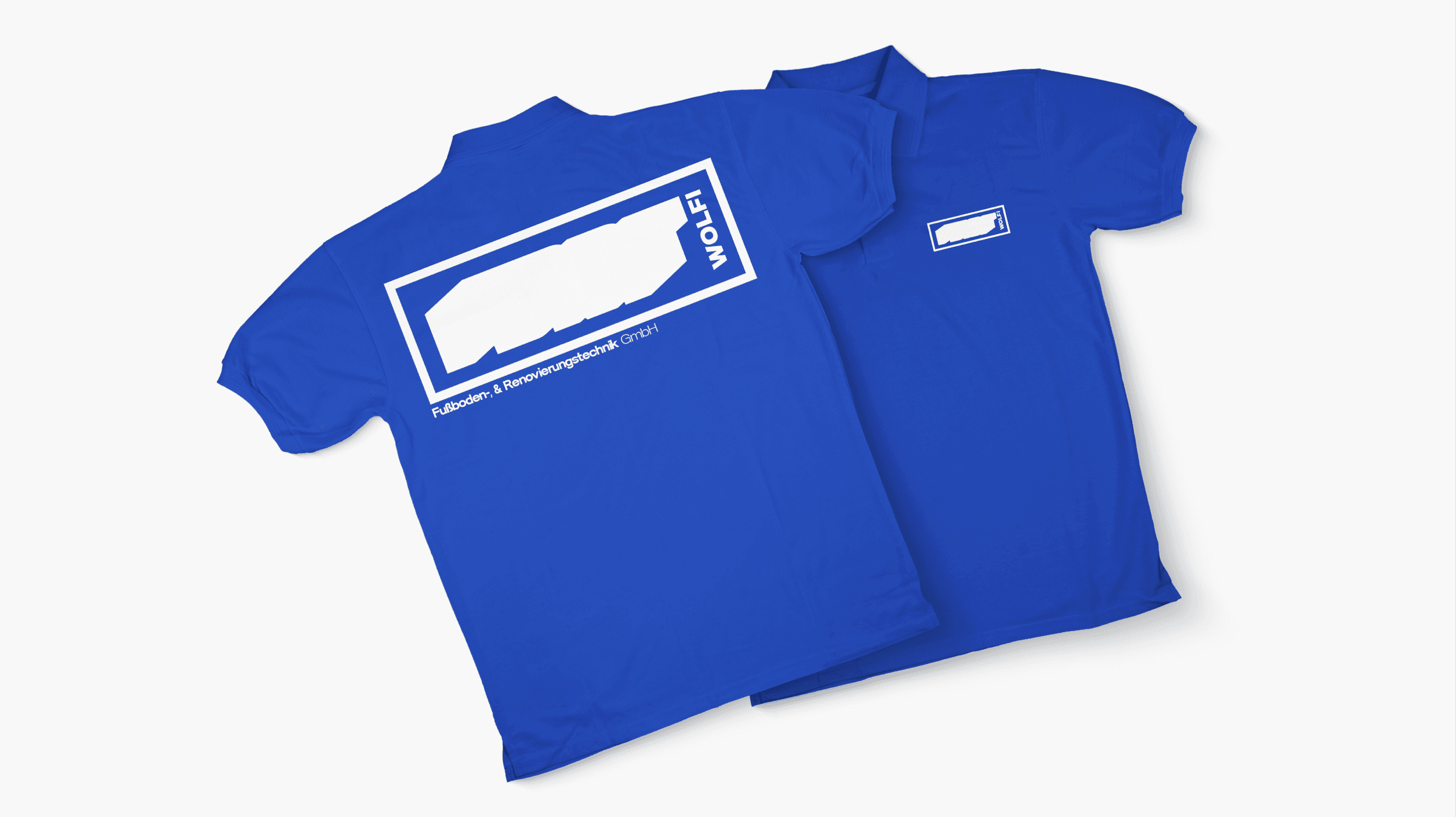 A black and white aerial photo of a surfer riding a wave. The image shows the surfer carving through the water, creating a dynamic spray of water around them.