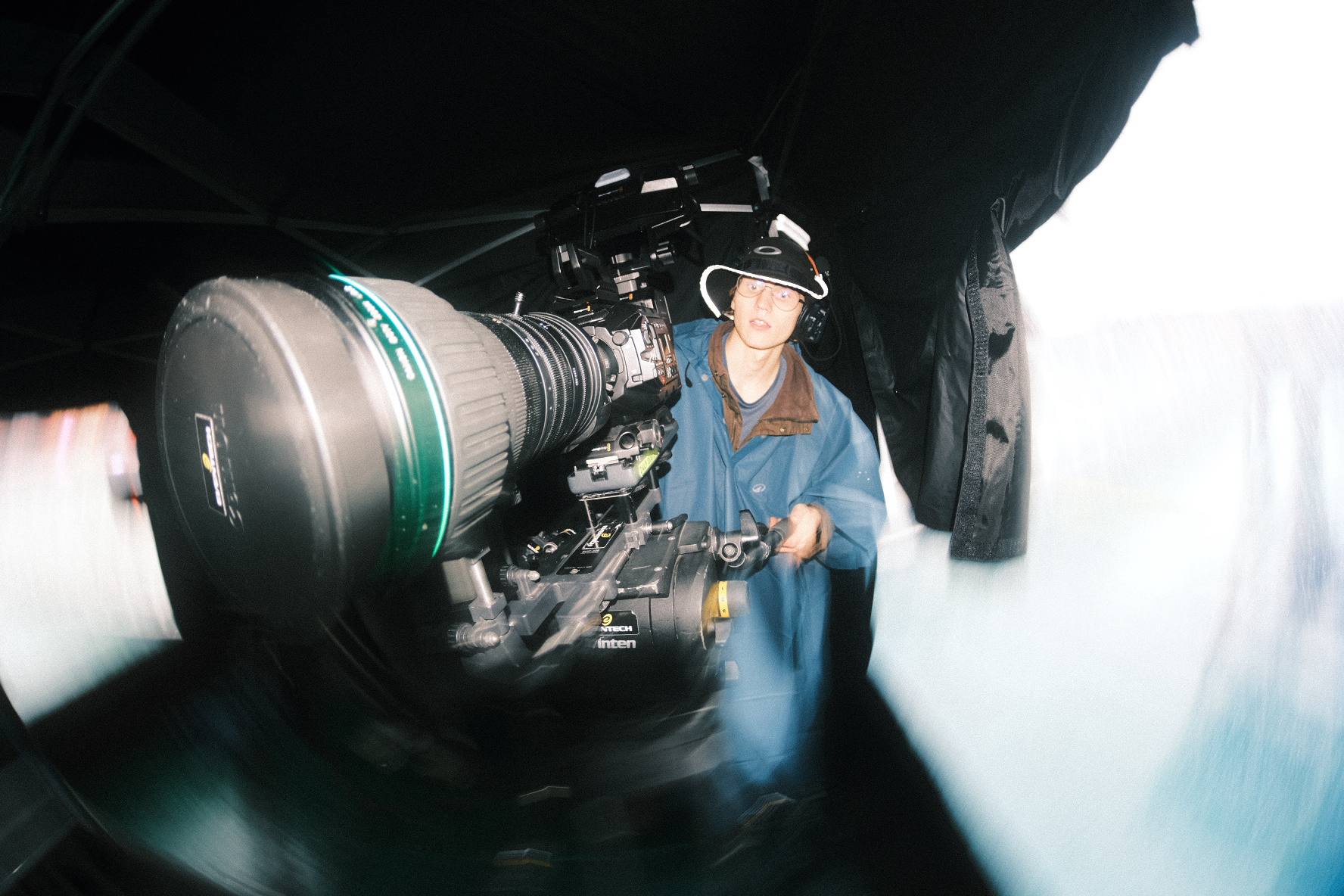 Camera operator with a broadcast camera and long lens