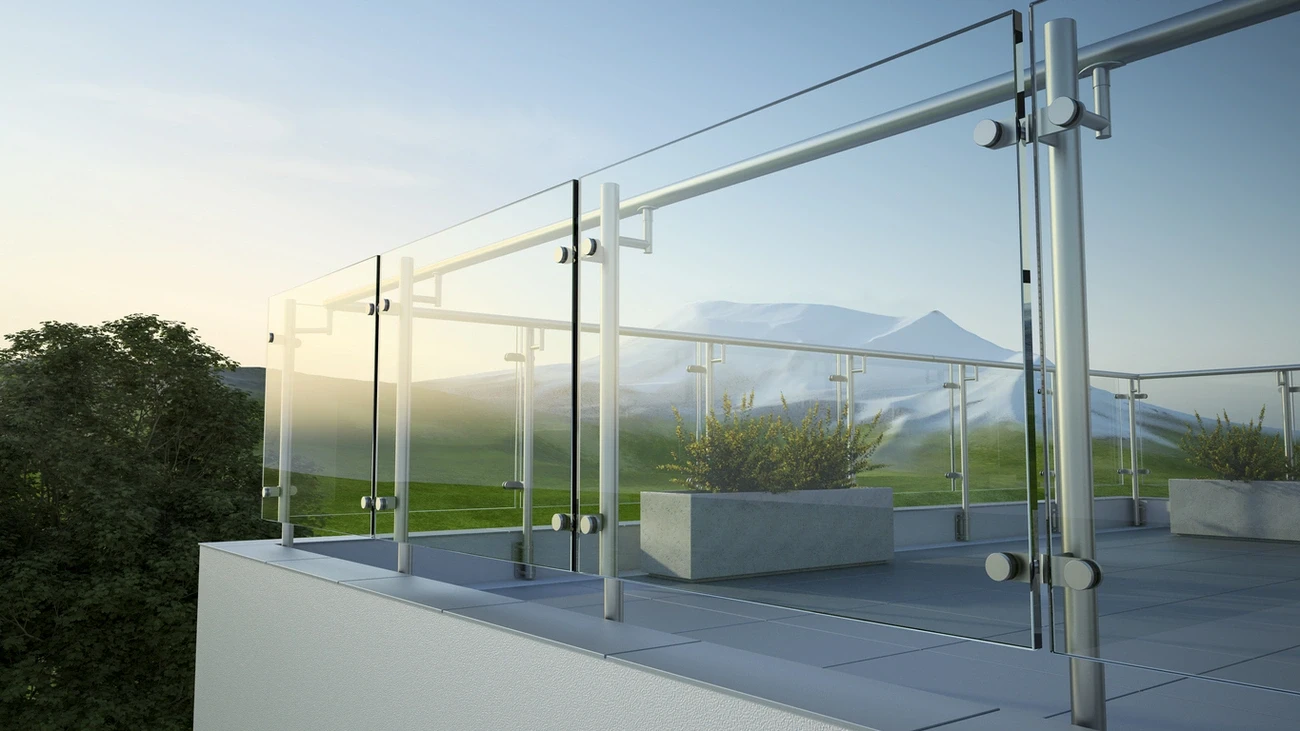 Modern glass railing installation on a balcony with metal supports overlooking a scenic mountain landscape.