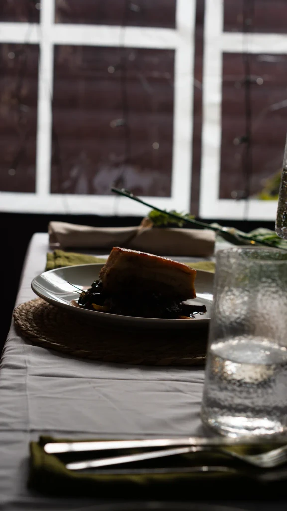 A laid dining table in the window light