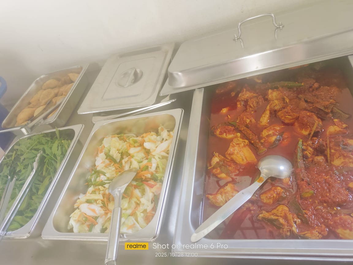 Buffet spread of food, including fresh vegetables and side dishes, served during the employee lunch treatment.