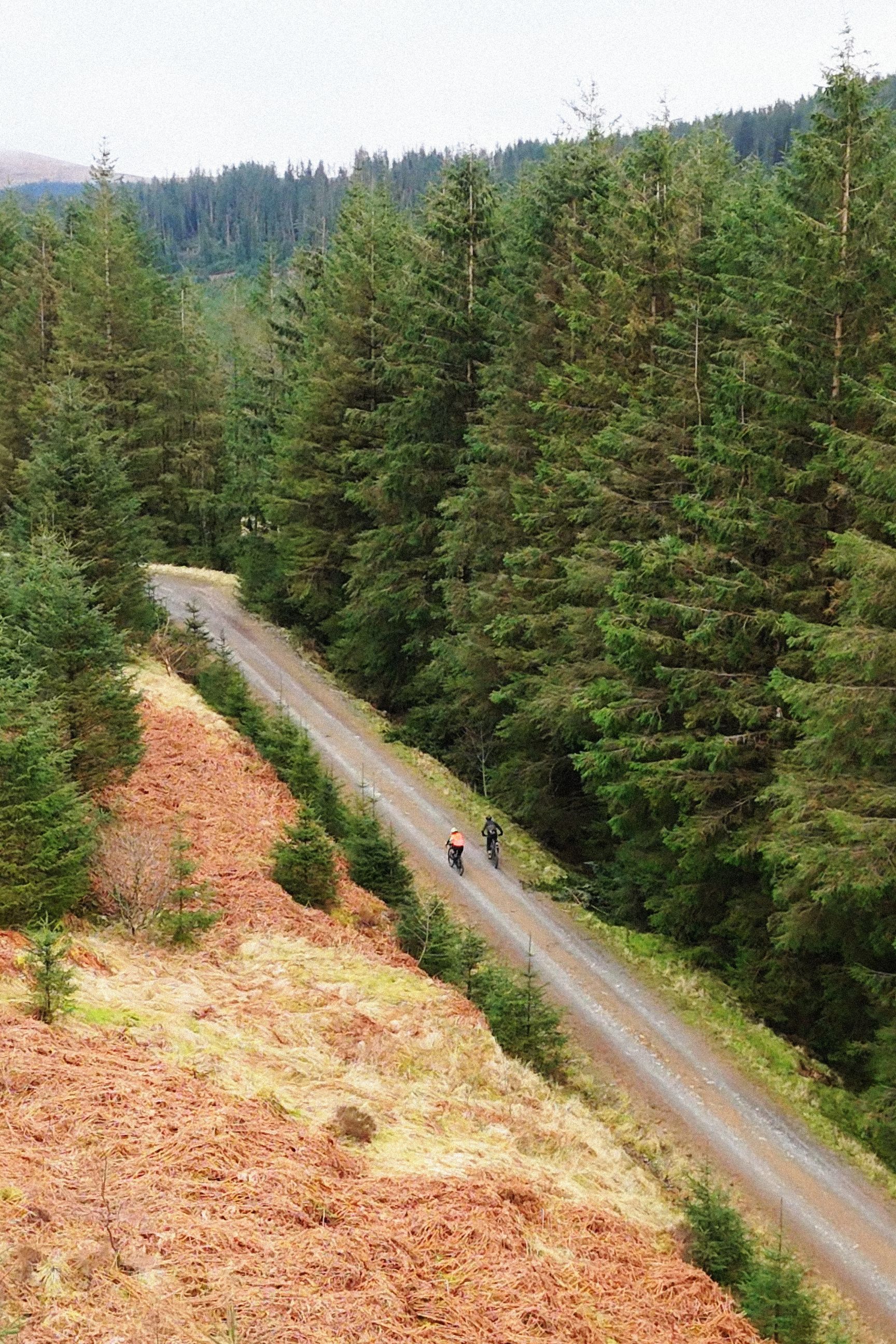 A drone shot of two cyclists in Scotland