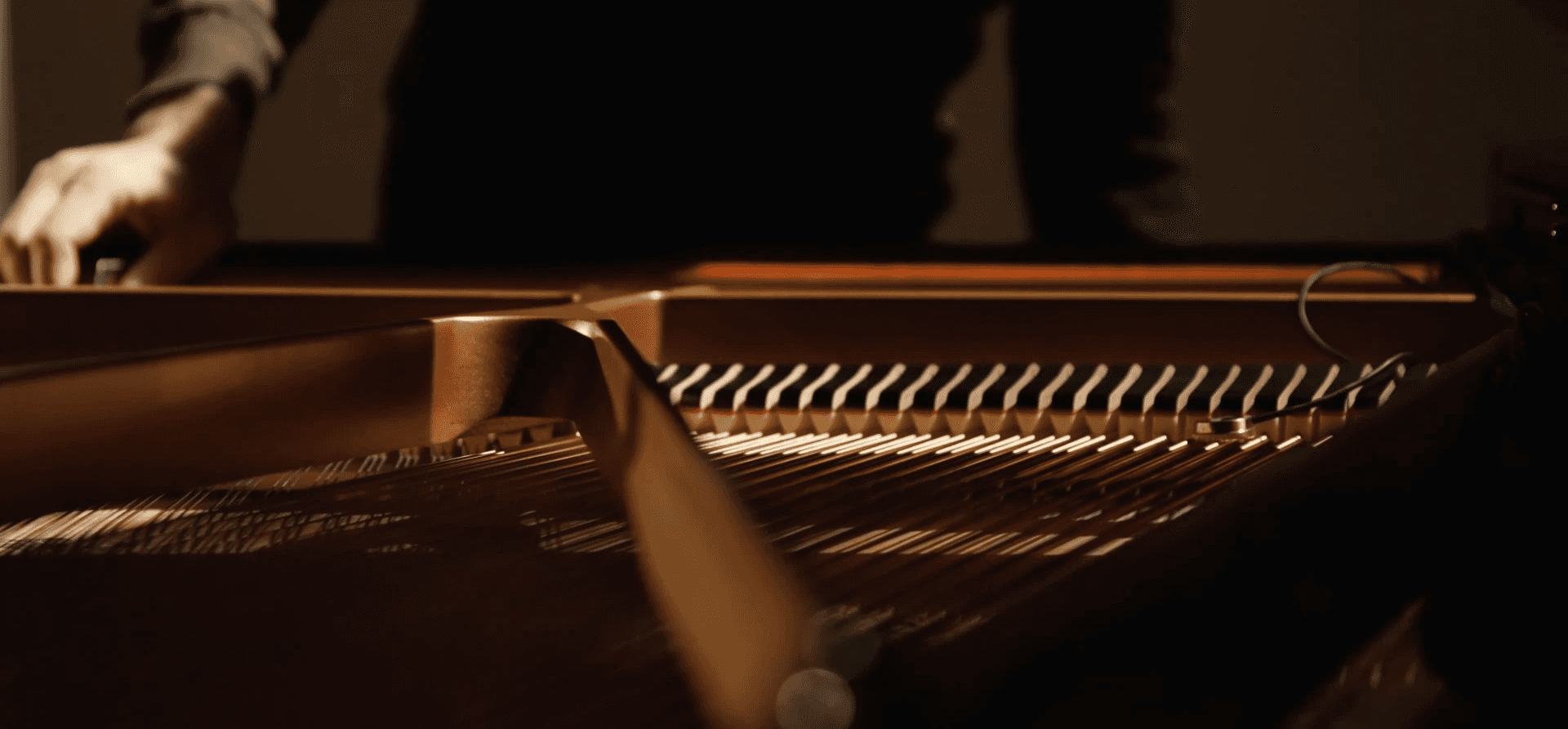 Contact sensor mounted on a bow, capturing vibration at the point of gesture.