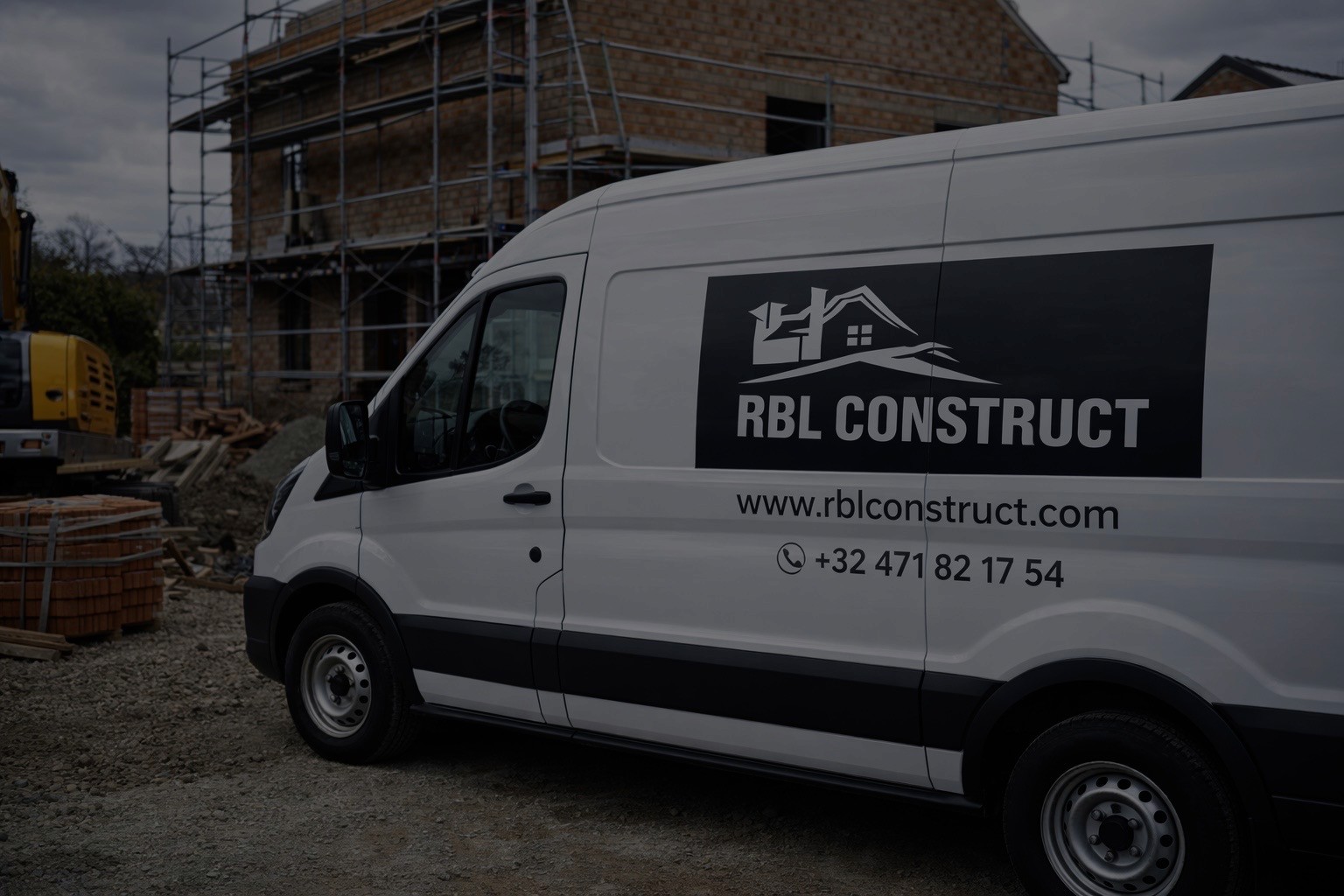Modern indoor space with large glass doors, lush greenery, and a cozy seating area visible beyond.