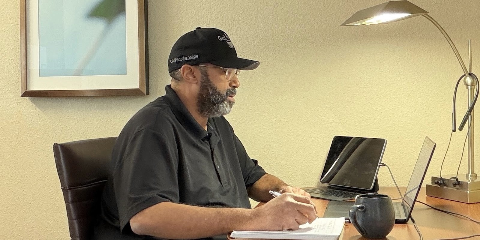 Ed Carter, founder of Carter’s Coffee Online, working at his desk, focused on quality and consistency.