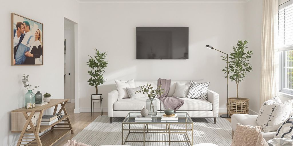 Stylishly staged living room with minimal furniture and decor.