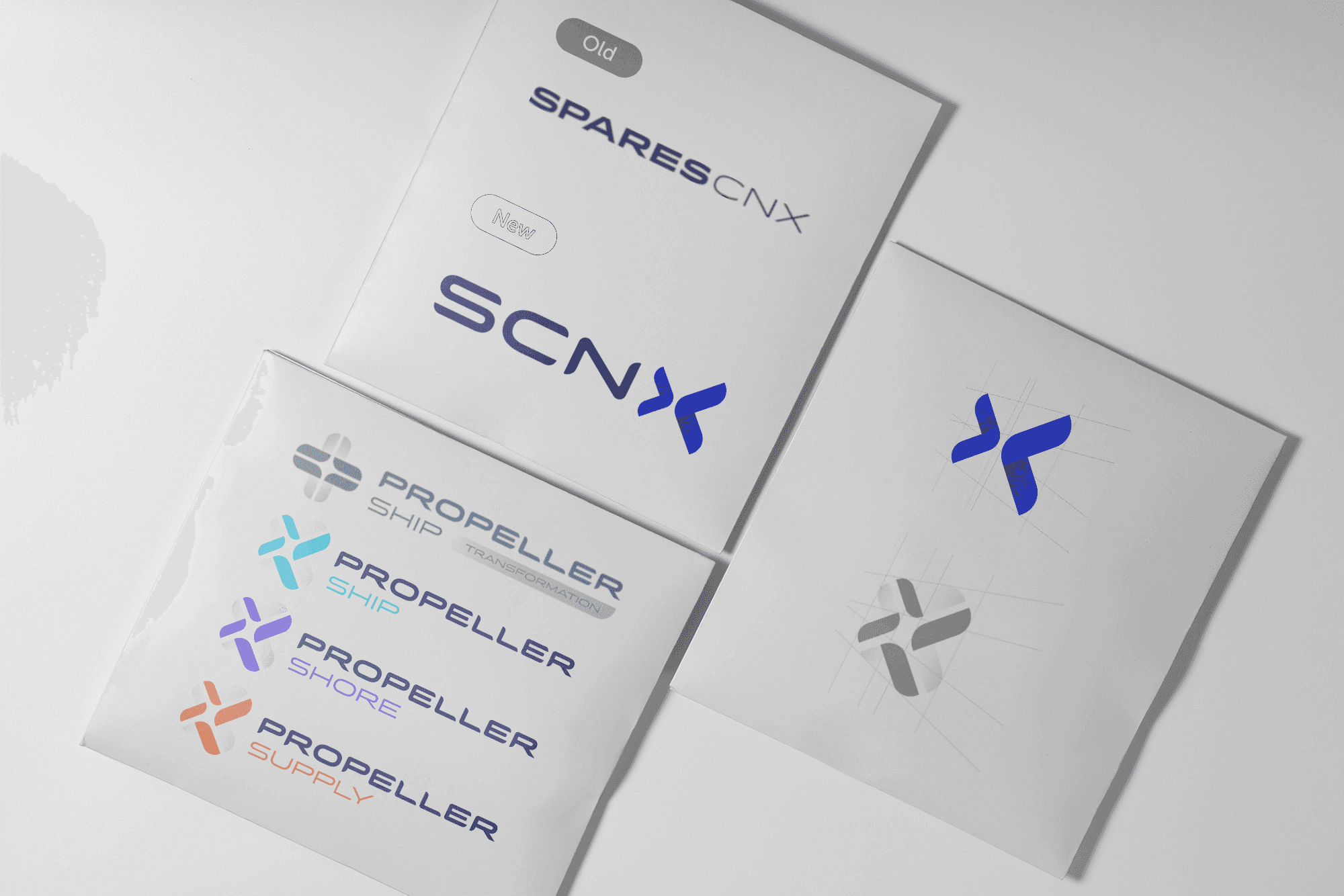 Abstract sculpture with eight teardrop-shaped arms radiating from the center, alternating in black and white, set against a soft gray background. Modern, symmetrical.