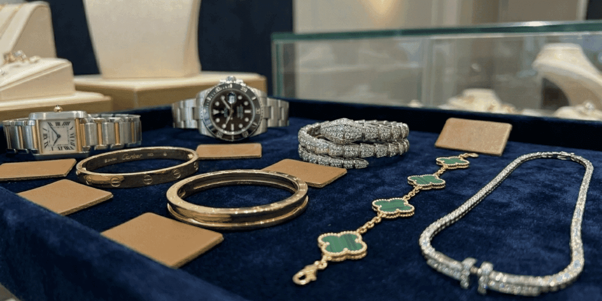 Luxury watches, bracelets, and necklaces displayed on velvet