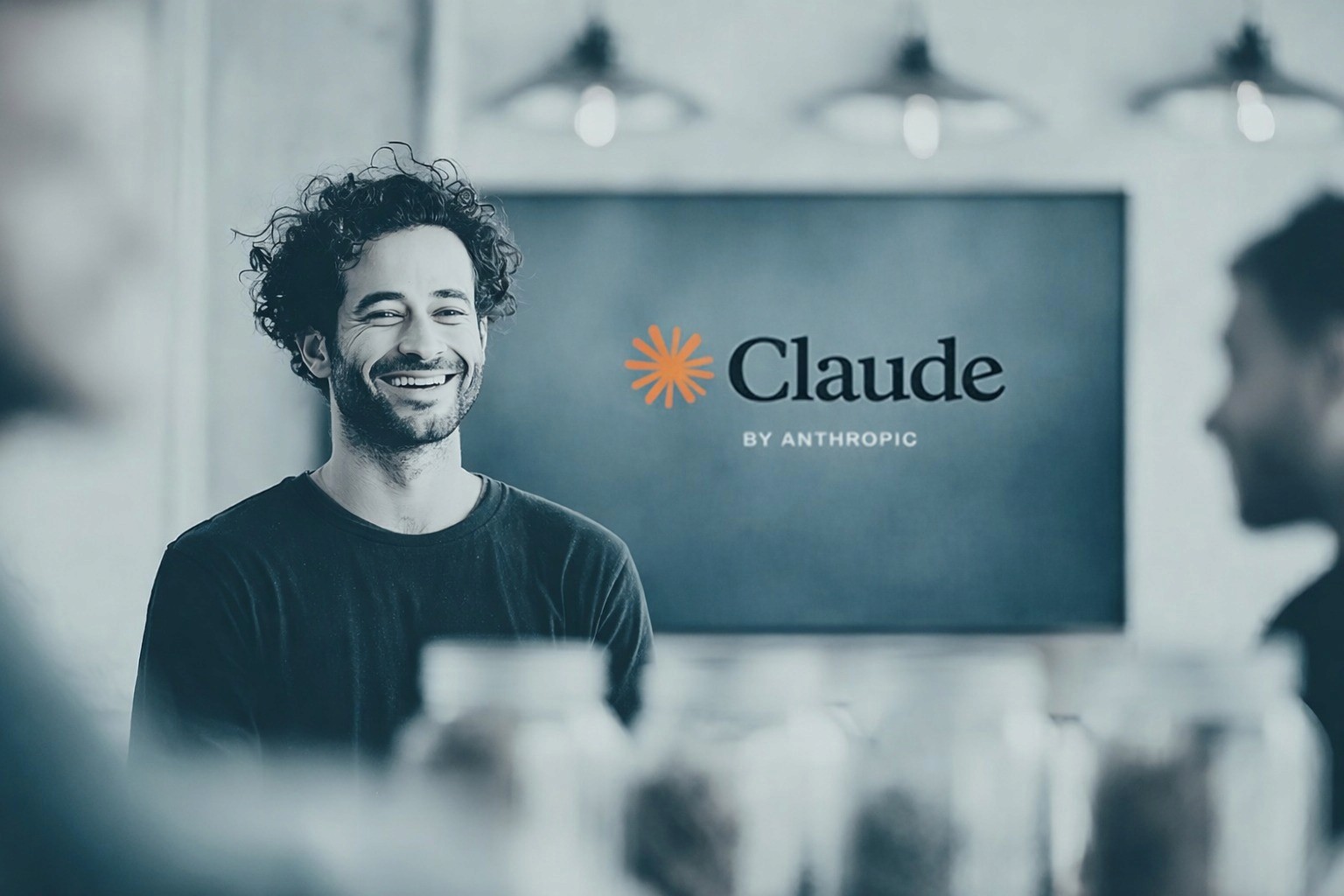 Close-up of a dark green leaf showing its textured surface and central vein against a muted background.
