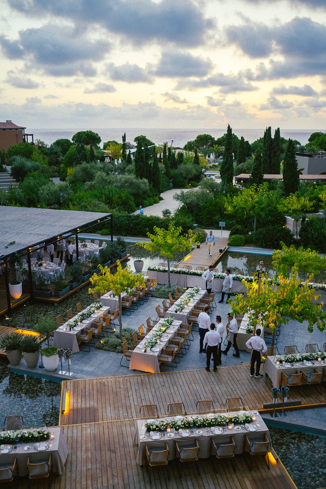 Bespoke wooden floral arch and rustic chairs for a luxury beach wedding ceremony in Greece