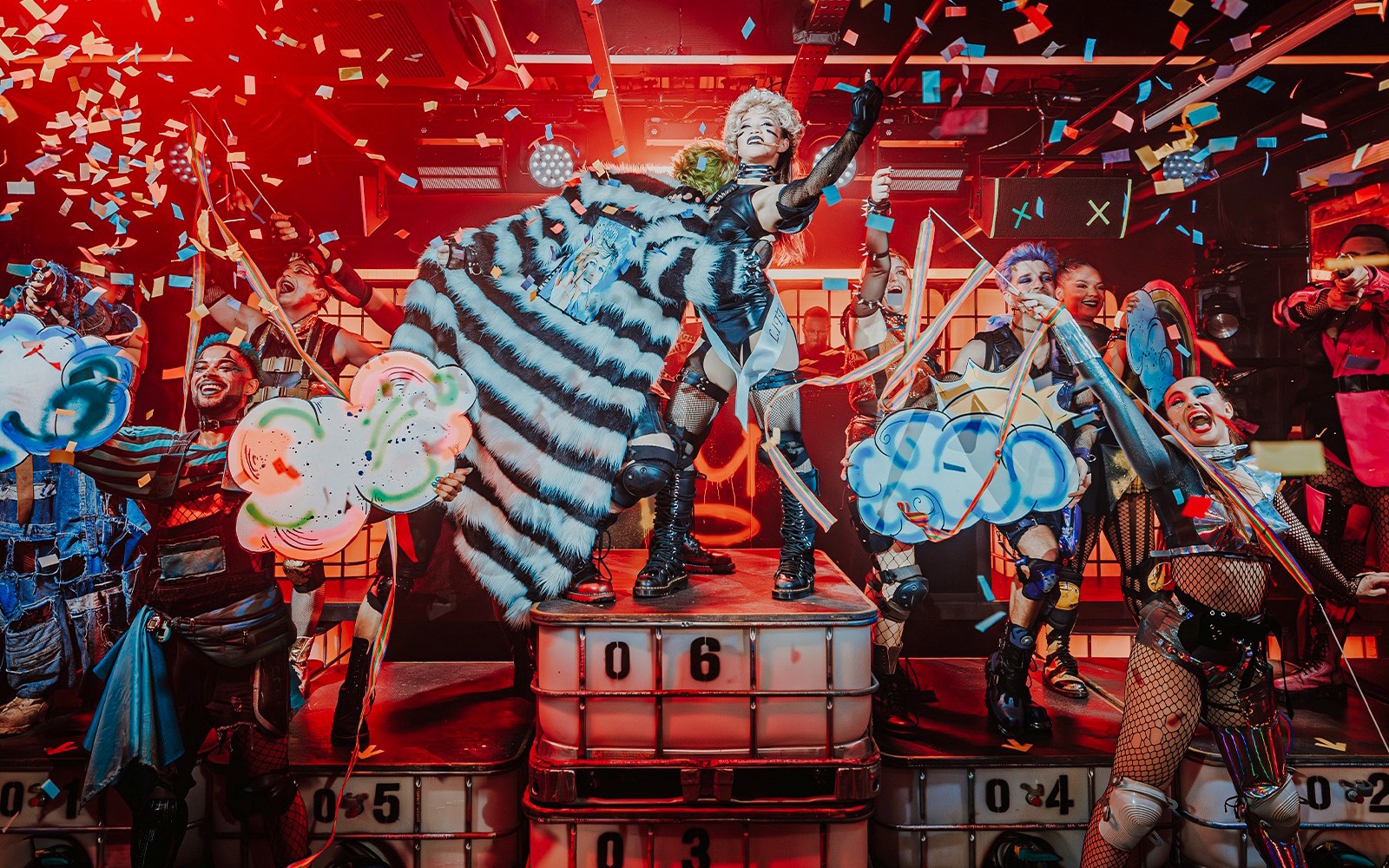 Performer on stage with colorful confetti at Oscar at the Crown show.
