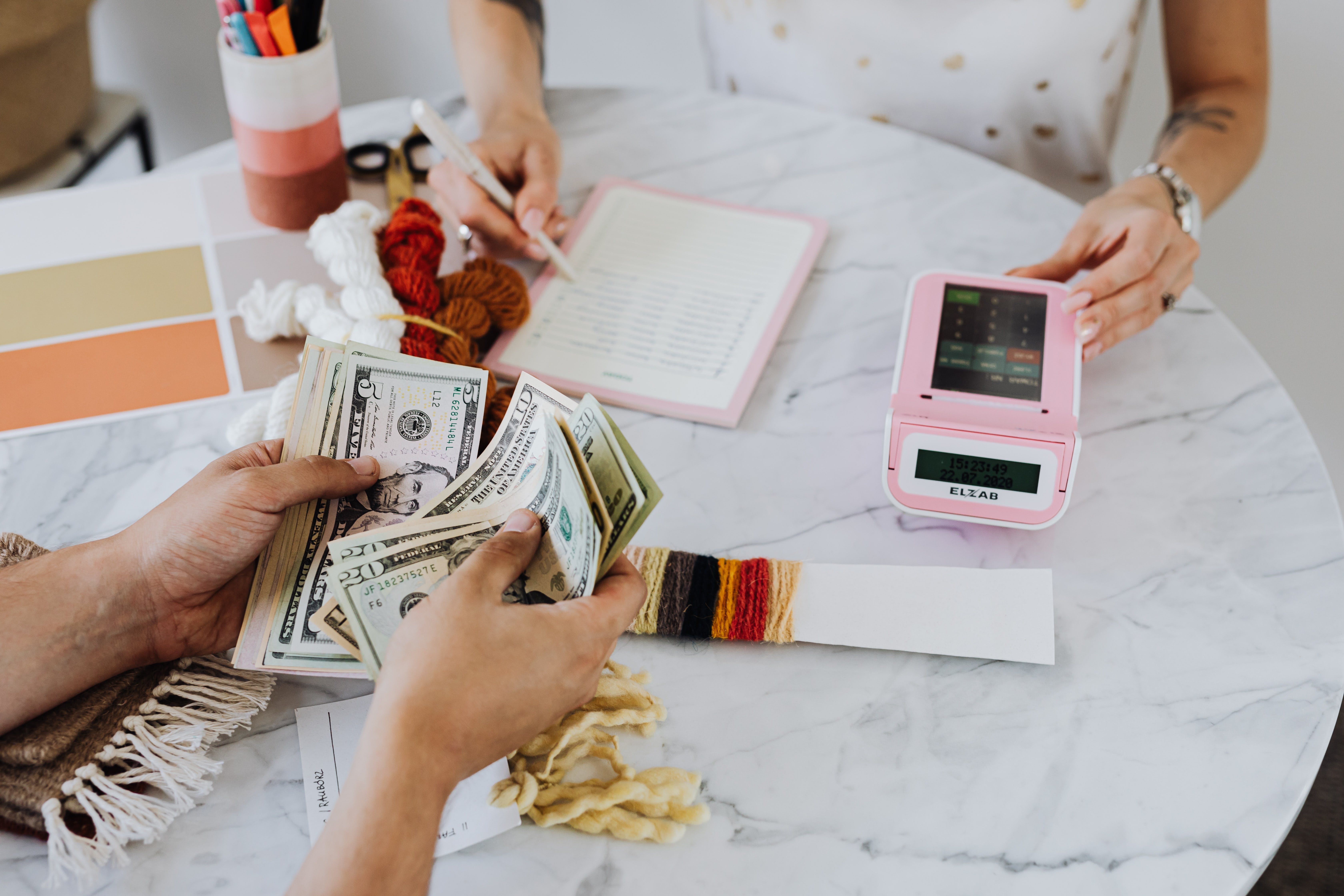 Woman counting bills to pay mortgage