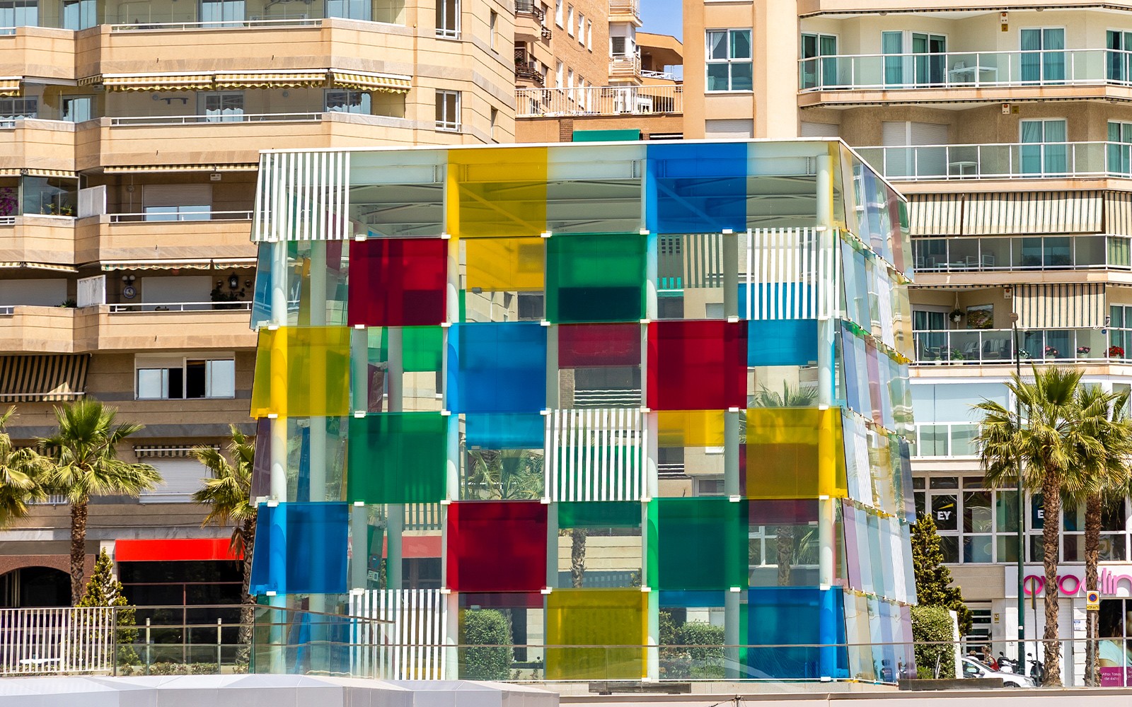 Colorful glass cube structure at Malaga's Pompidou Centre.