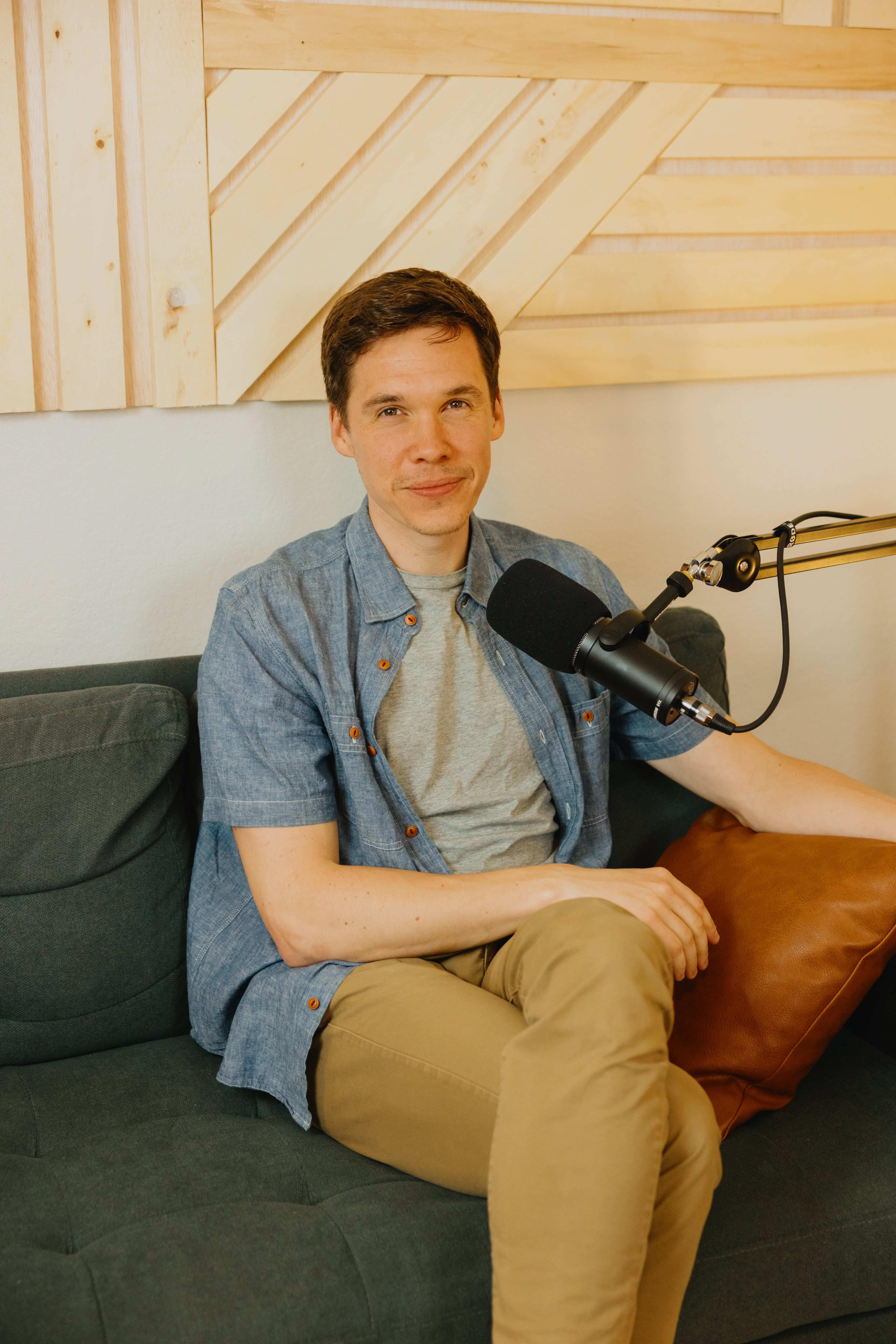 Woman in crewneck standing against wood wall