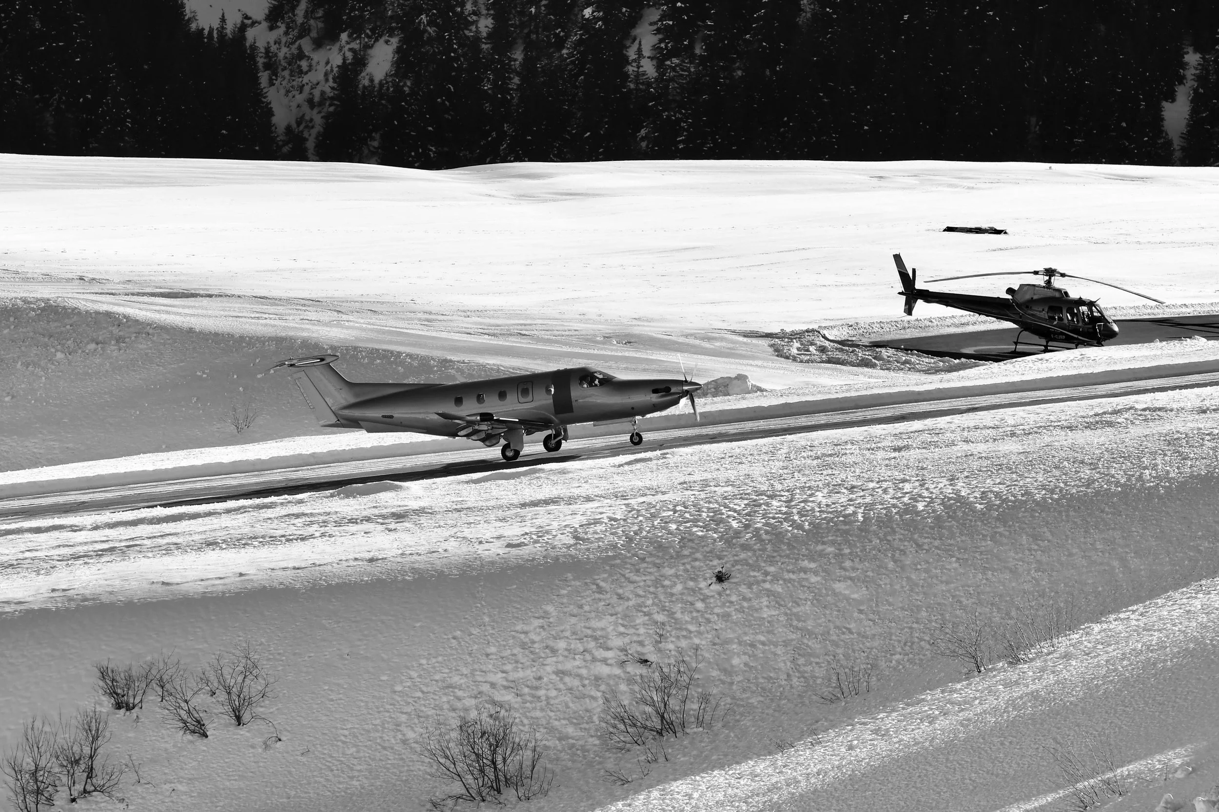 Aerial view of a tropical beach coastline with a remote landing strip alongside turquoise waters
