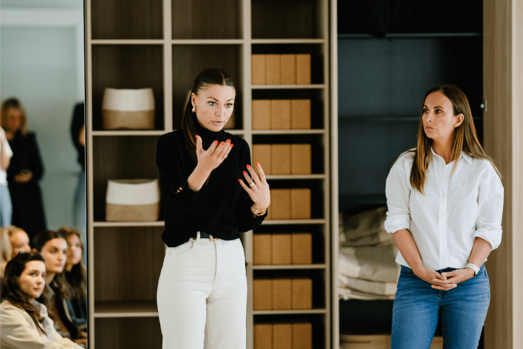 A woman practicing yoga in a spacious studio, positioned on a mat.