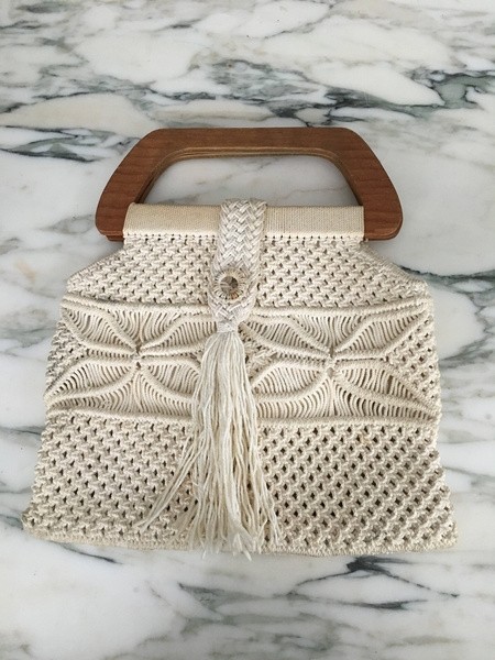 Handcrafted macrame handbag with wooden handle and fringe detail