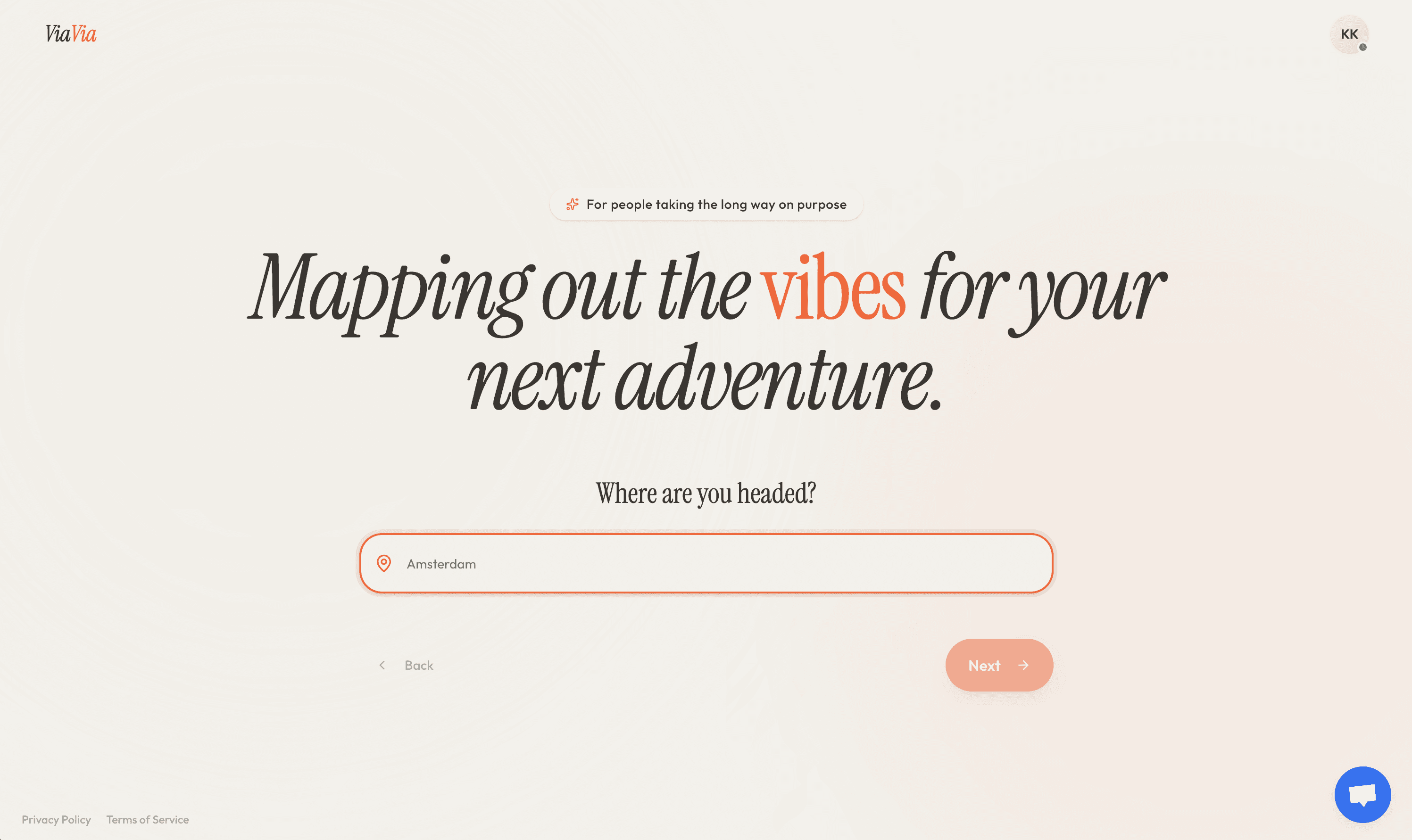 Desert road leading through golden plains toward rocky cliffs under a clear blue sky in AlUla.