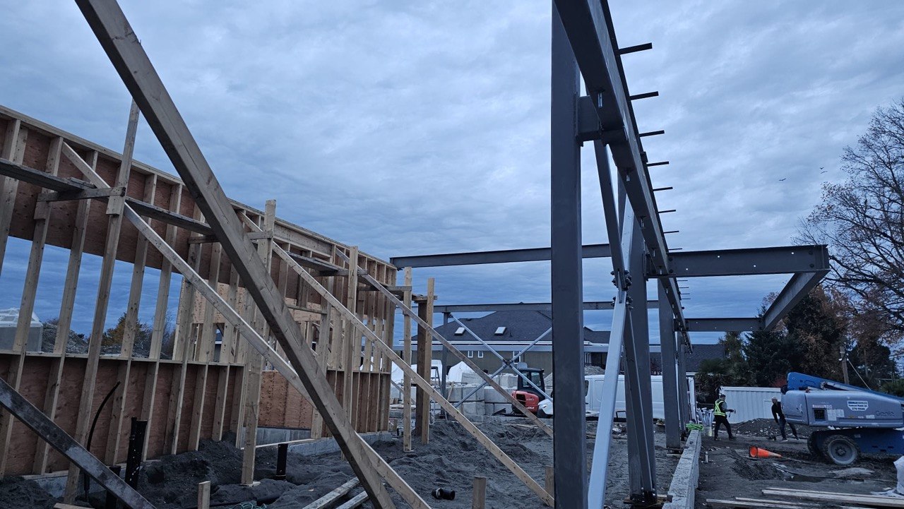 Steel beams, columns and diagonal bracing integrated with timber walls