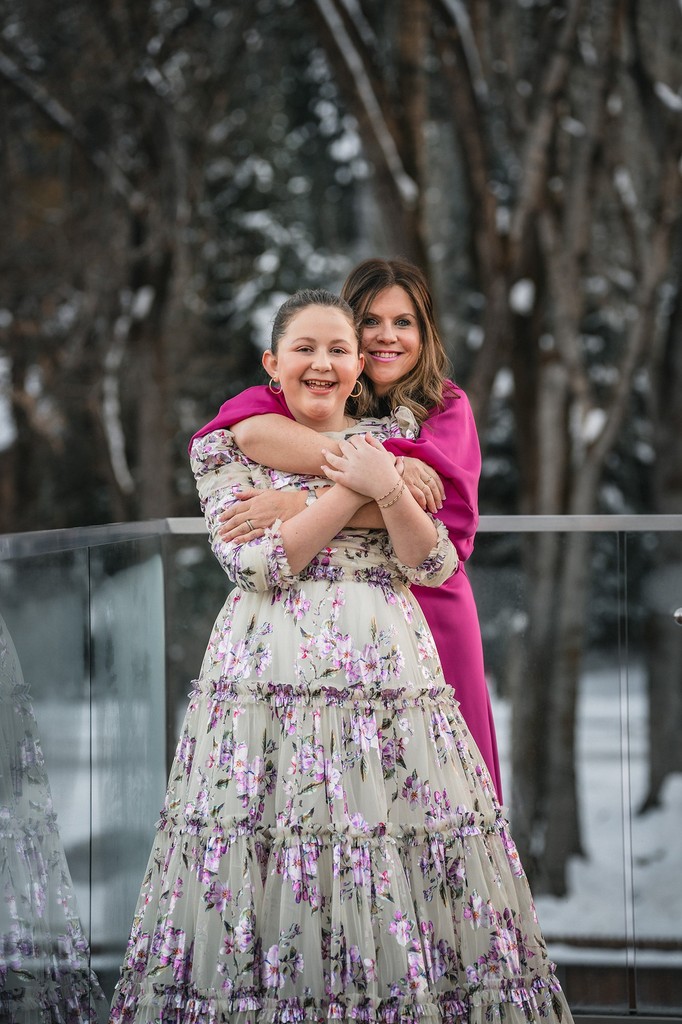 Mother and daughter sharing a hug during a bat mitzvah weekend