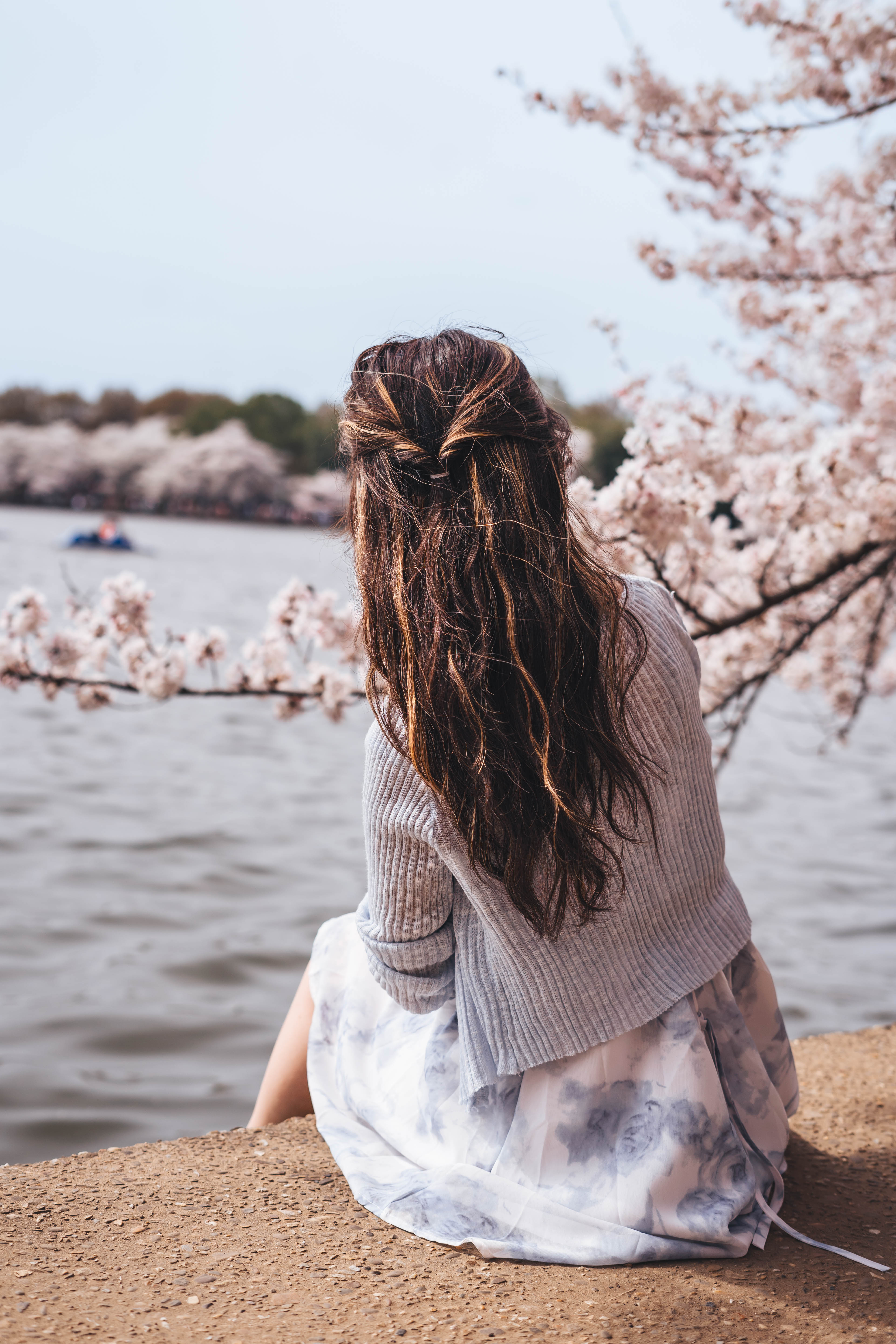 Open book with dried flowers on white fabric