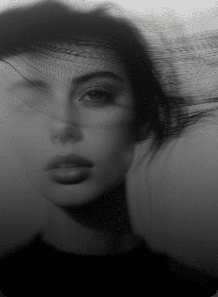 Artistic black and white portrait of a woman with hair motion blur.
