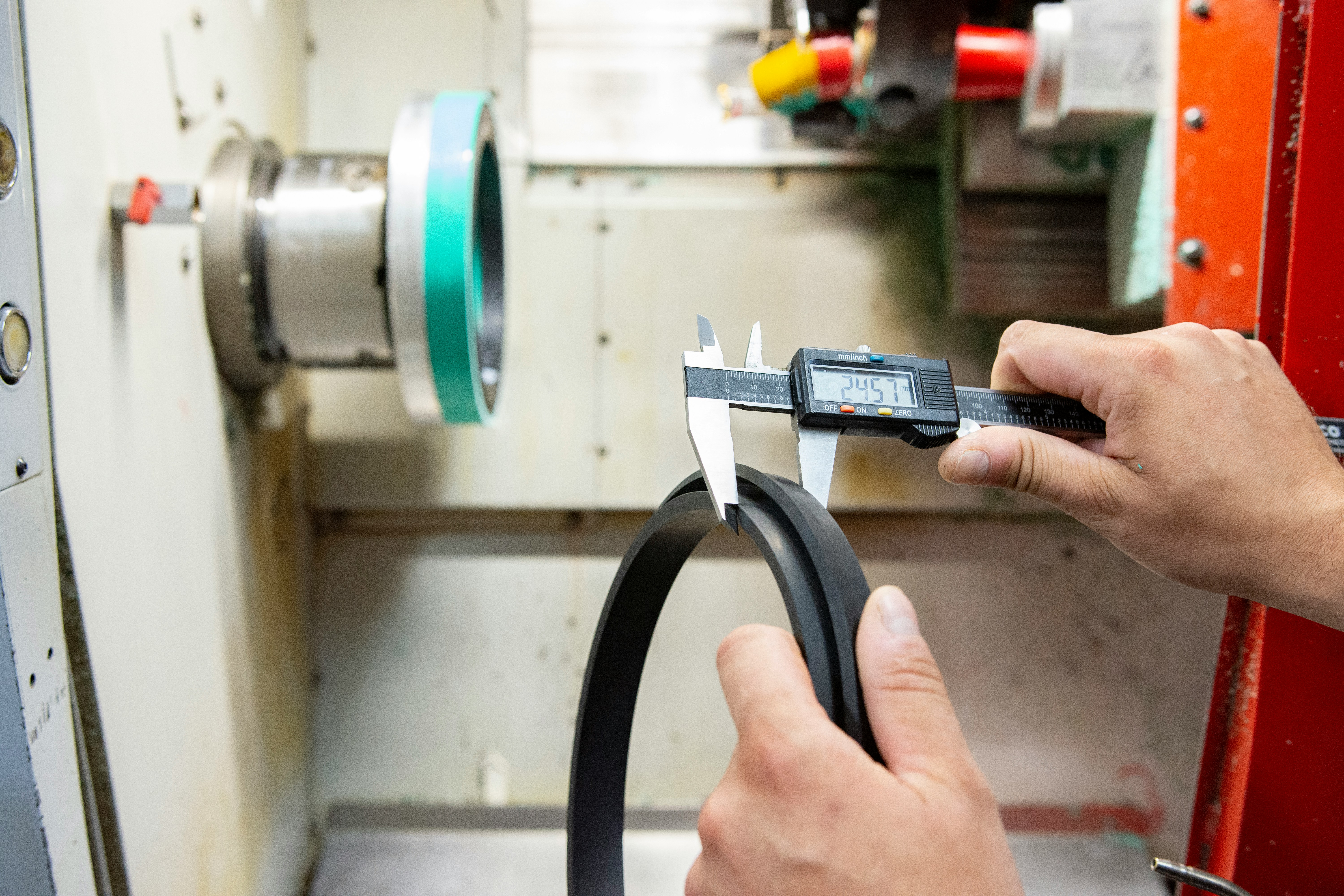 a man working on a machine with a pair of scissors